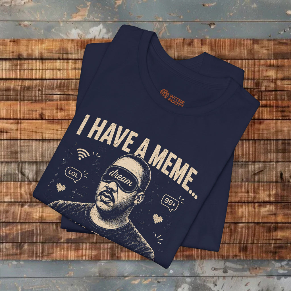 Folded navy blue t-shirt with graphic design and text on a wooden surface