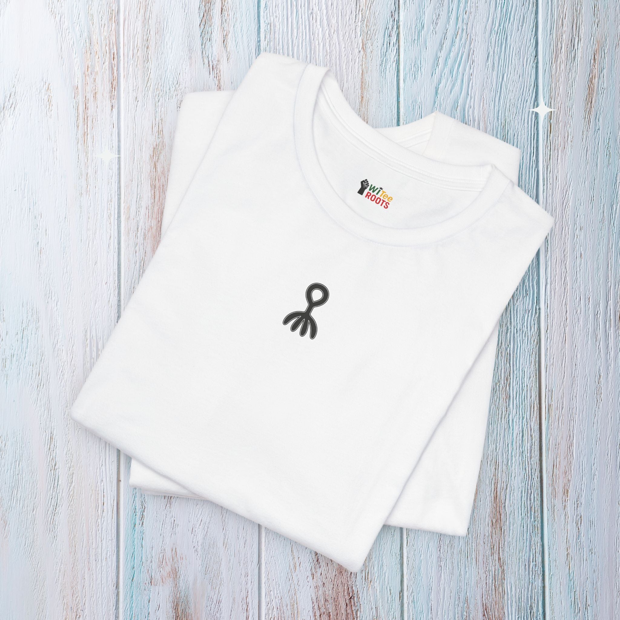 White t-shirt with black logo on a light wooden surface