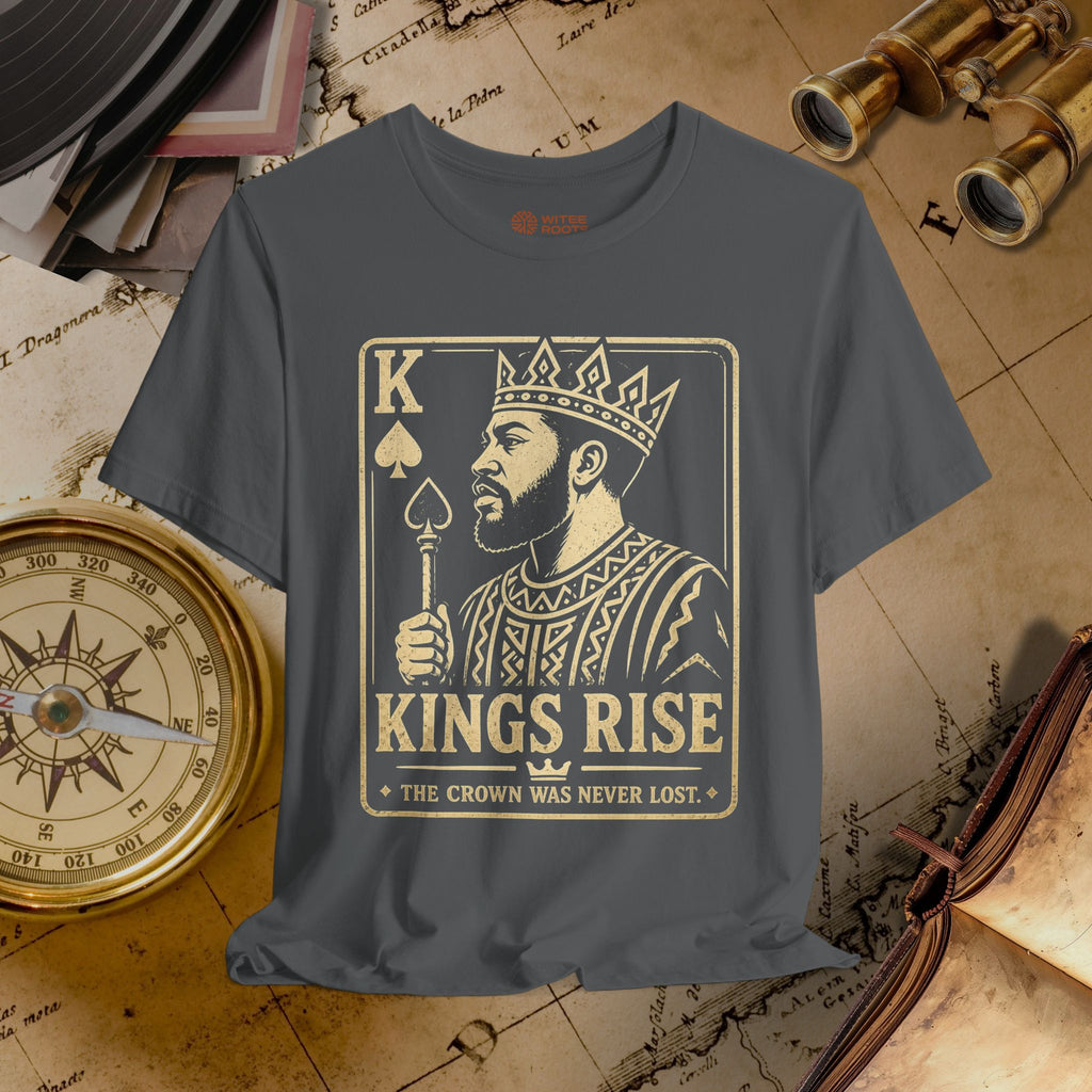 Gray t-shirt with a graphic design of a king holding a crown and the text 'Kings Rise' on a vintage map background.