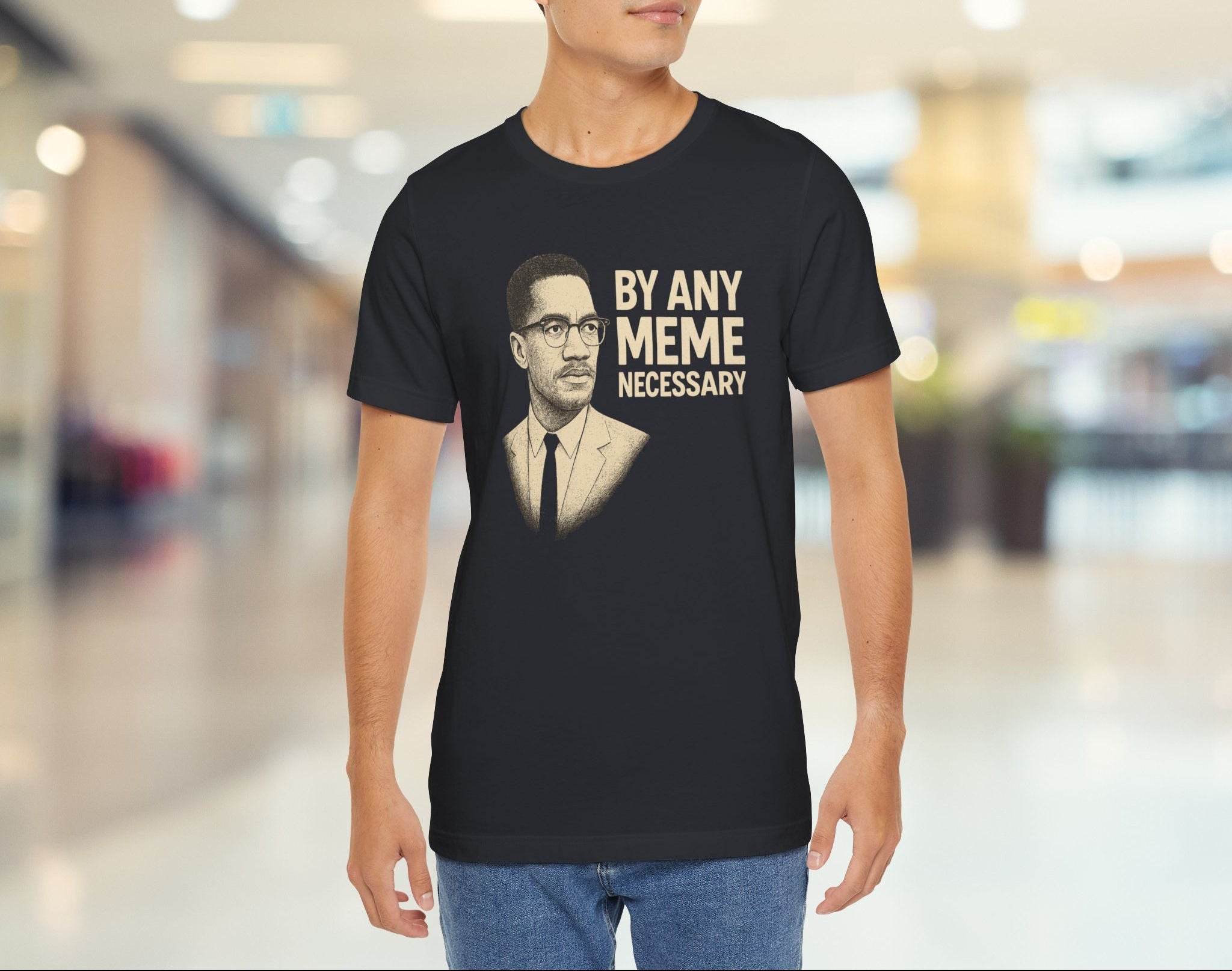 Person wearing a black t-shirt with a graphic and text in a mall setting