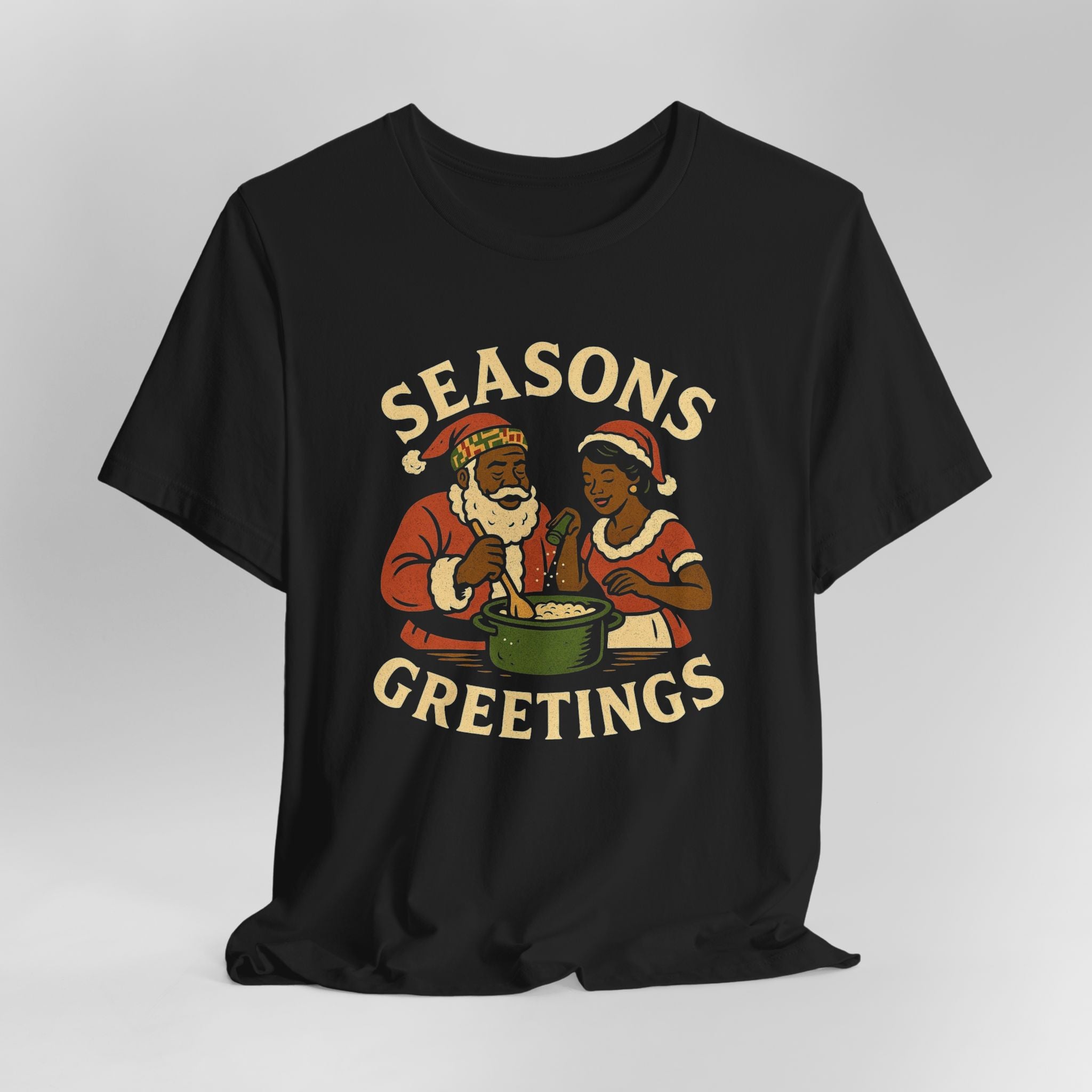 Black t-shirt with 'Seasons Greetings' graphic featuring two people in Santa hats on a gray background