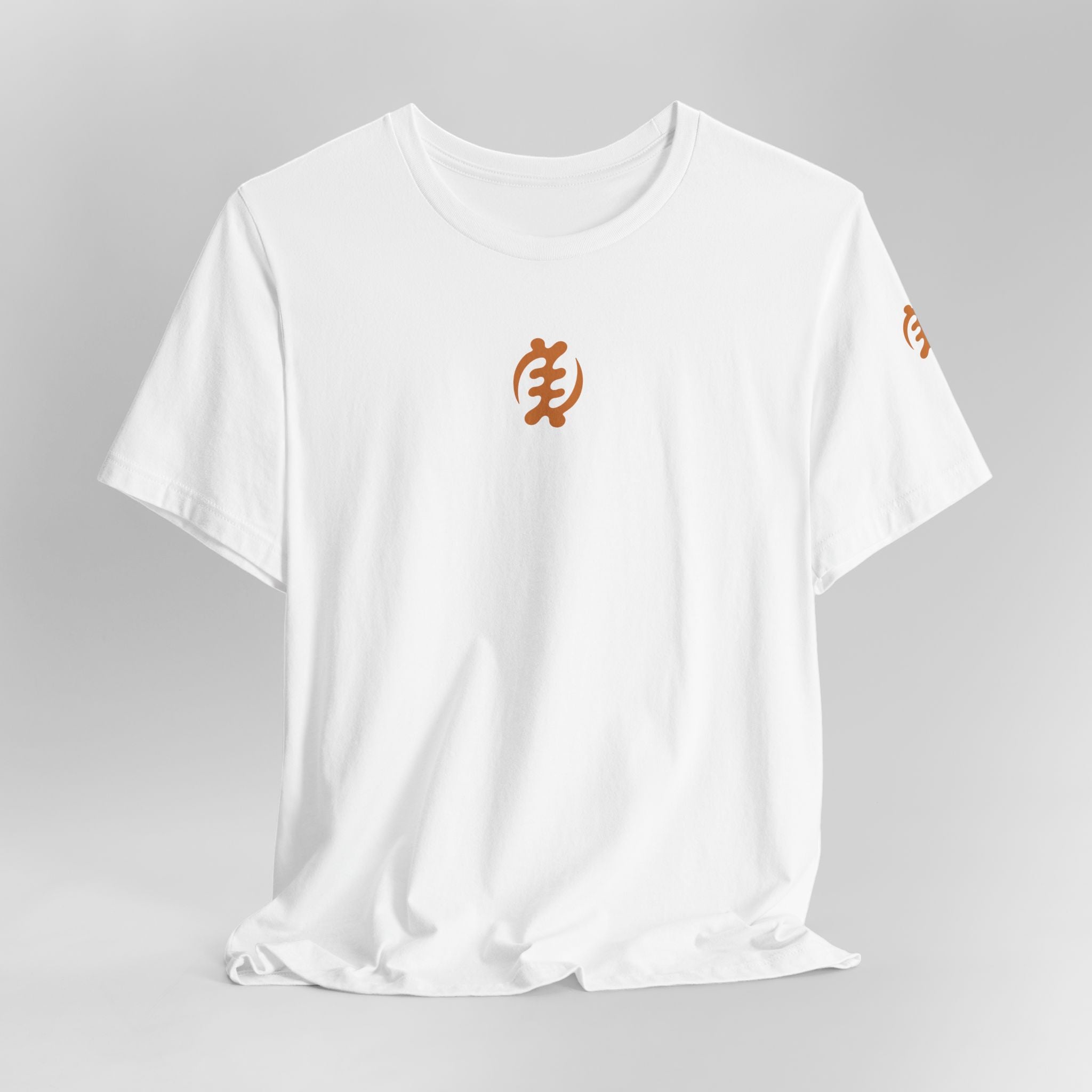 White t-shirt with orange symbols on a gray background