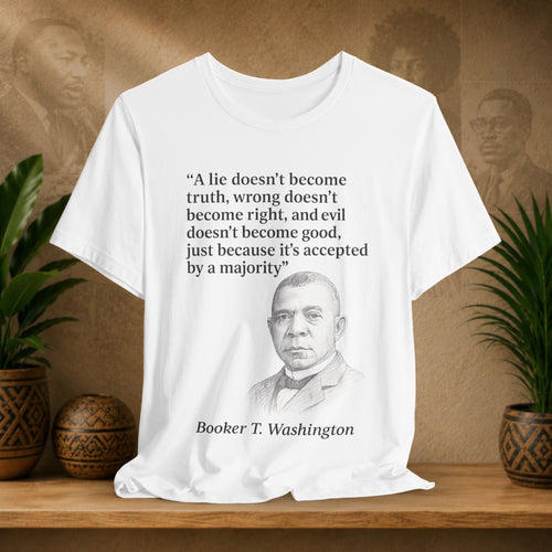 White t-shirt with Booker T. Washington's quote on a wooden shelf with plants and decorative items.