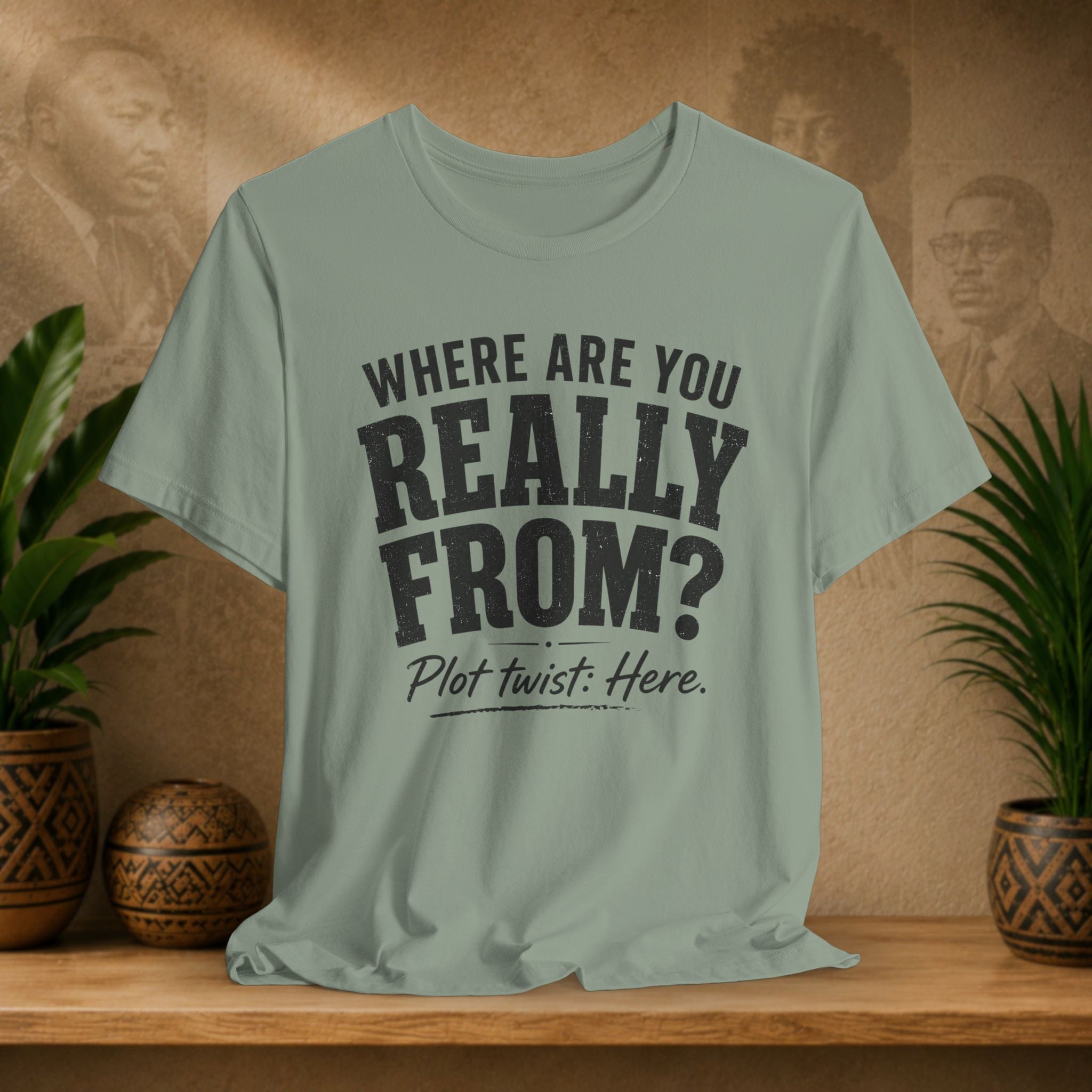Light green t-shirt with text on a wooden surface with plants and a textured wall background