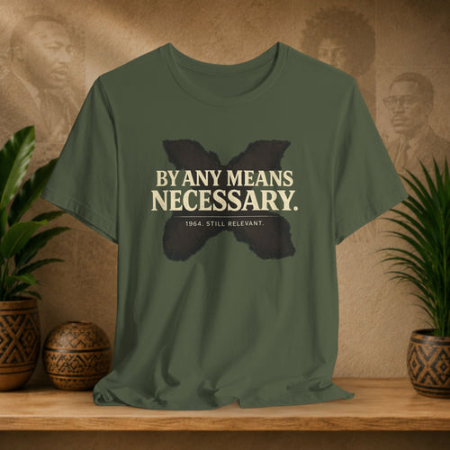 Green t-shirt with text and butterfly graphic on a wooden surface with decorative items.