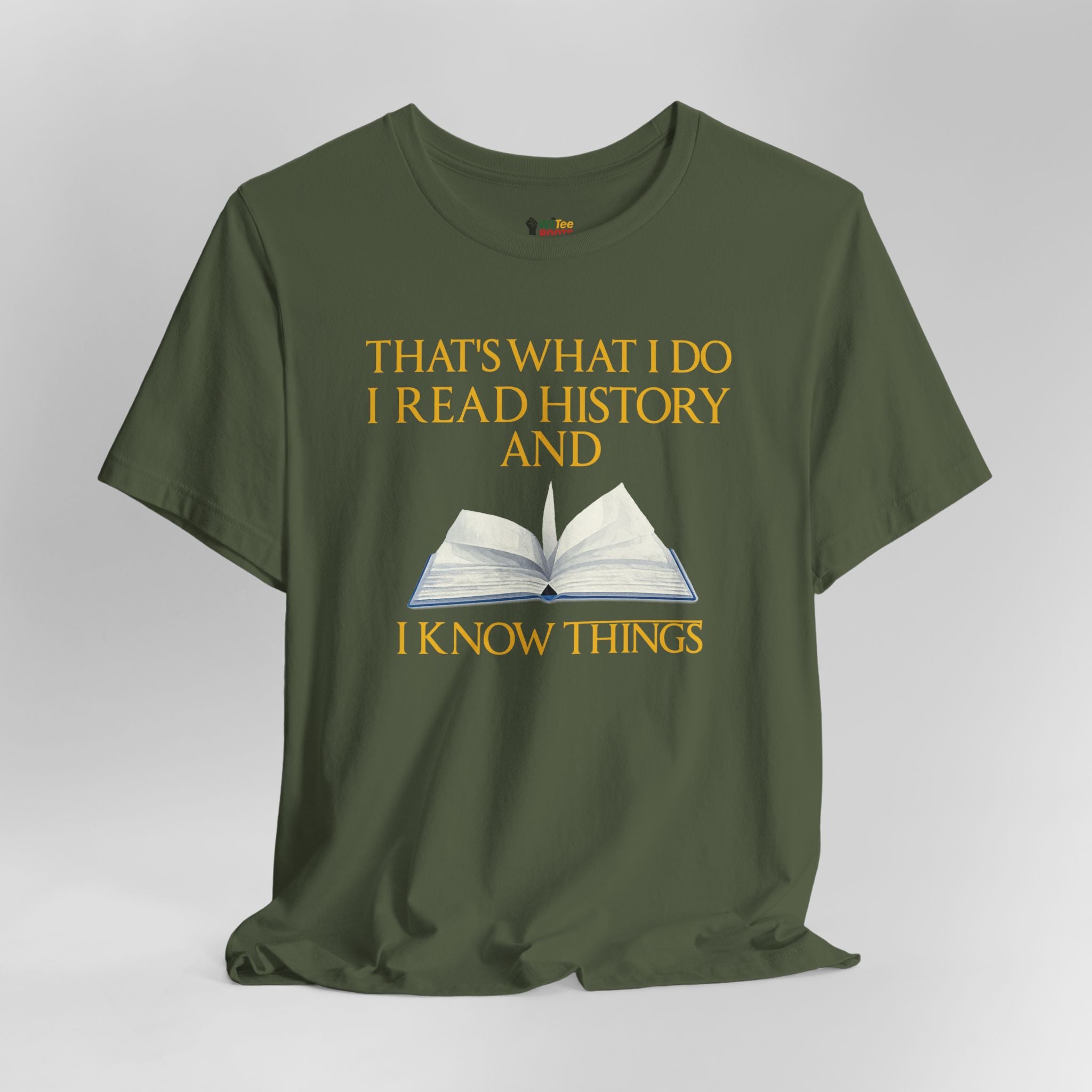 Green t-shirt with yellow text and an open book graphic on a gray background