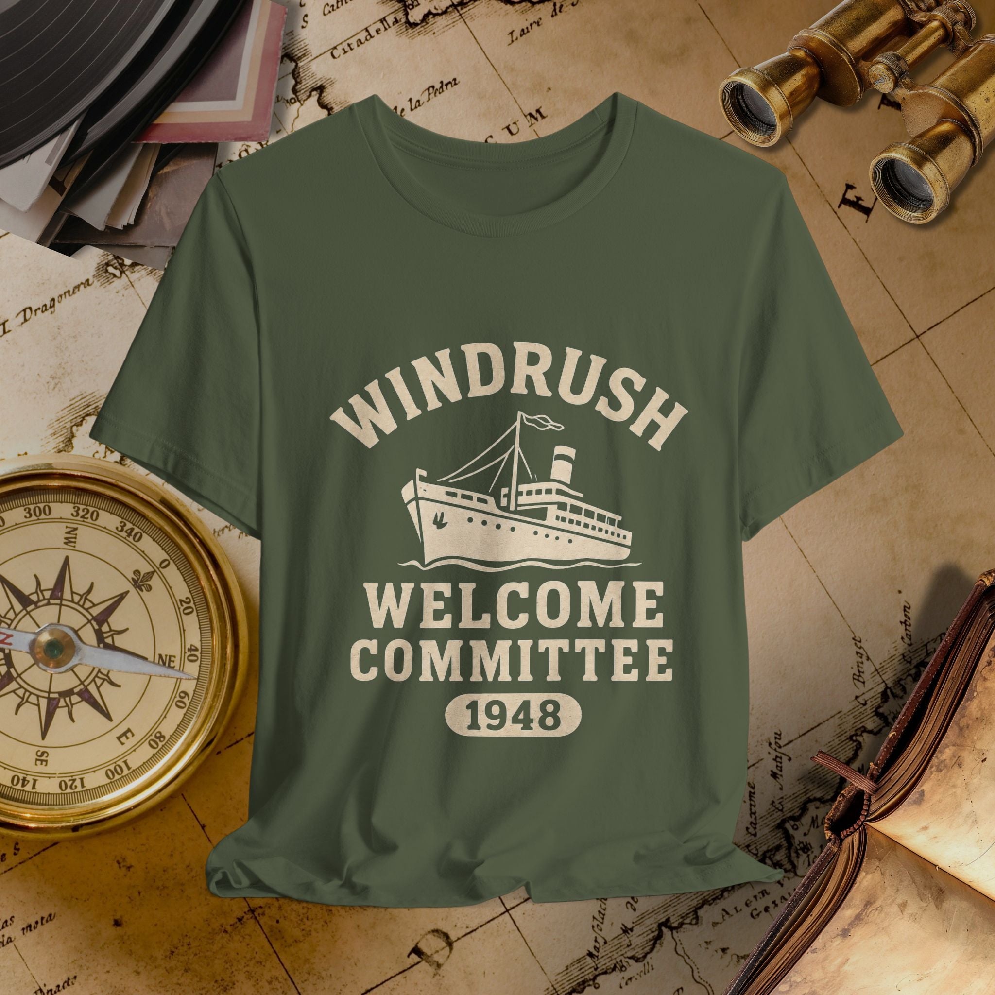 Green t-shirt with 'Windrush Welcome Committee 1948' design on a vintage map background.