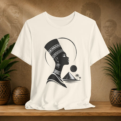 Beige t-shirt with a black silhouette design of a woman with a headdress on a wooden shelf.
