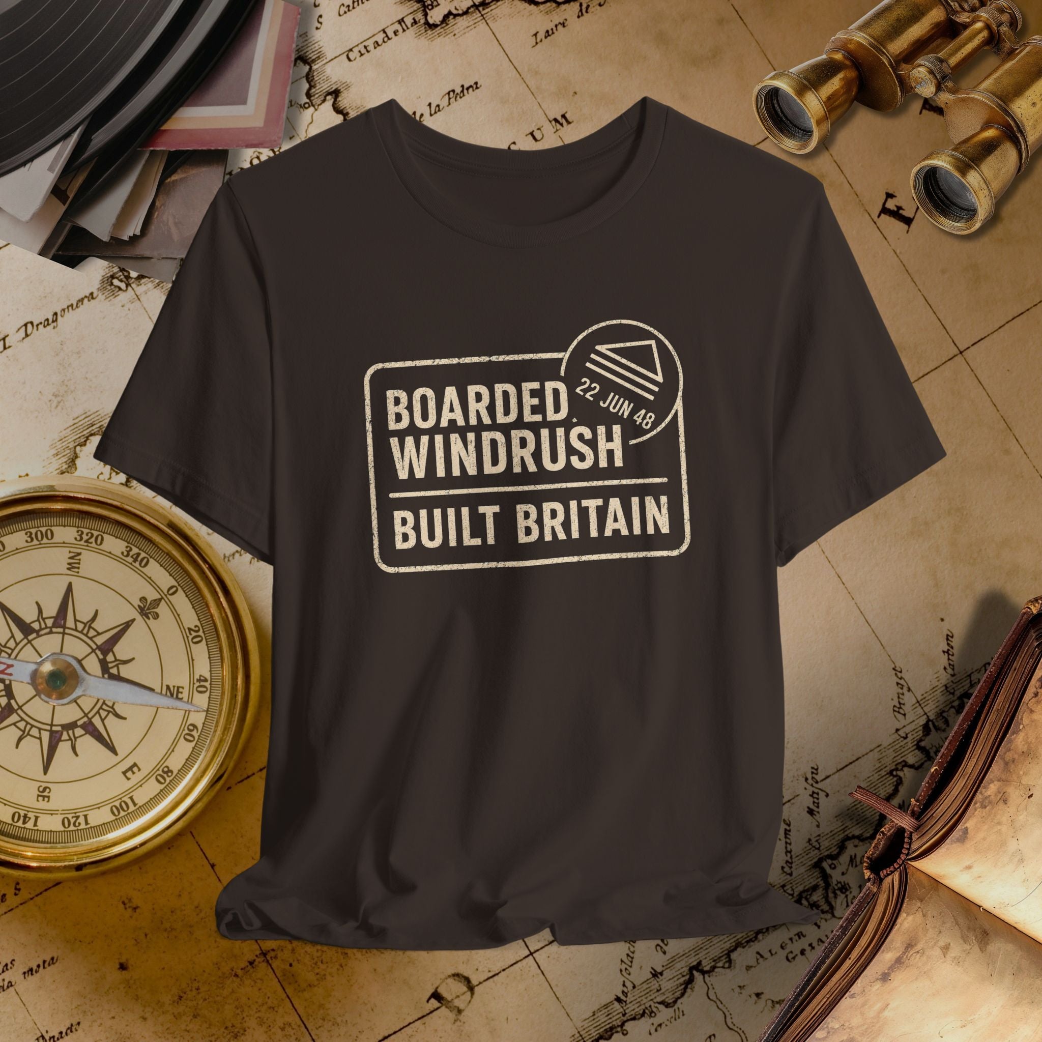 brown t-shirt with 'Boarded Windrush Built Britain' text on a vintage map background