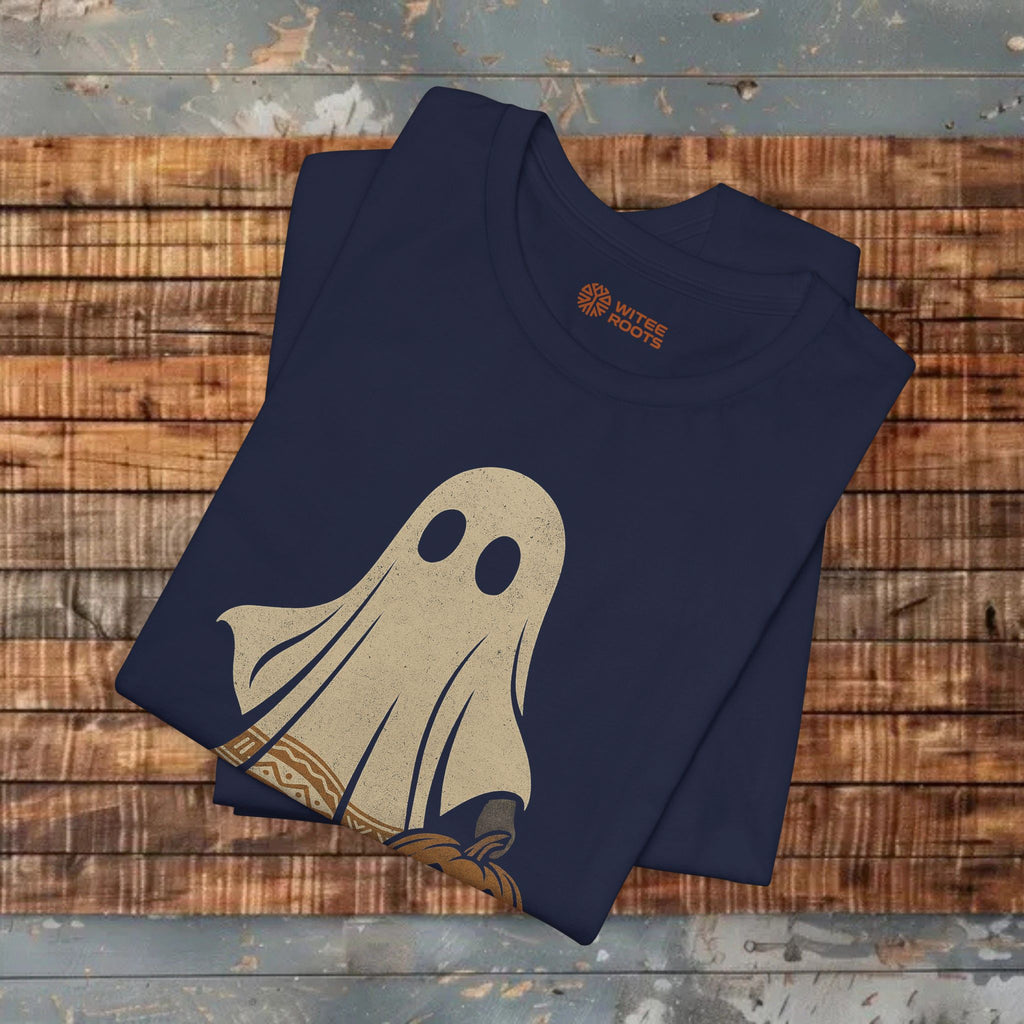 Folded navy blue t-shirt with a beige ghost design on a wooden surface