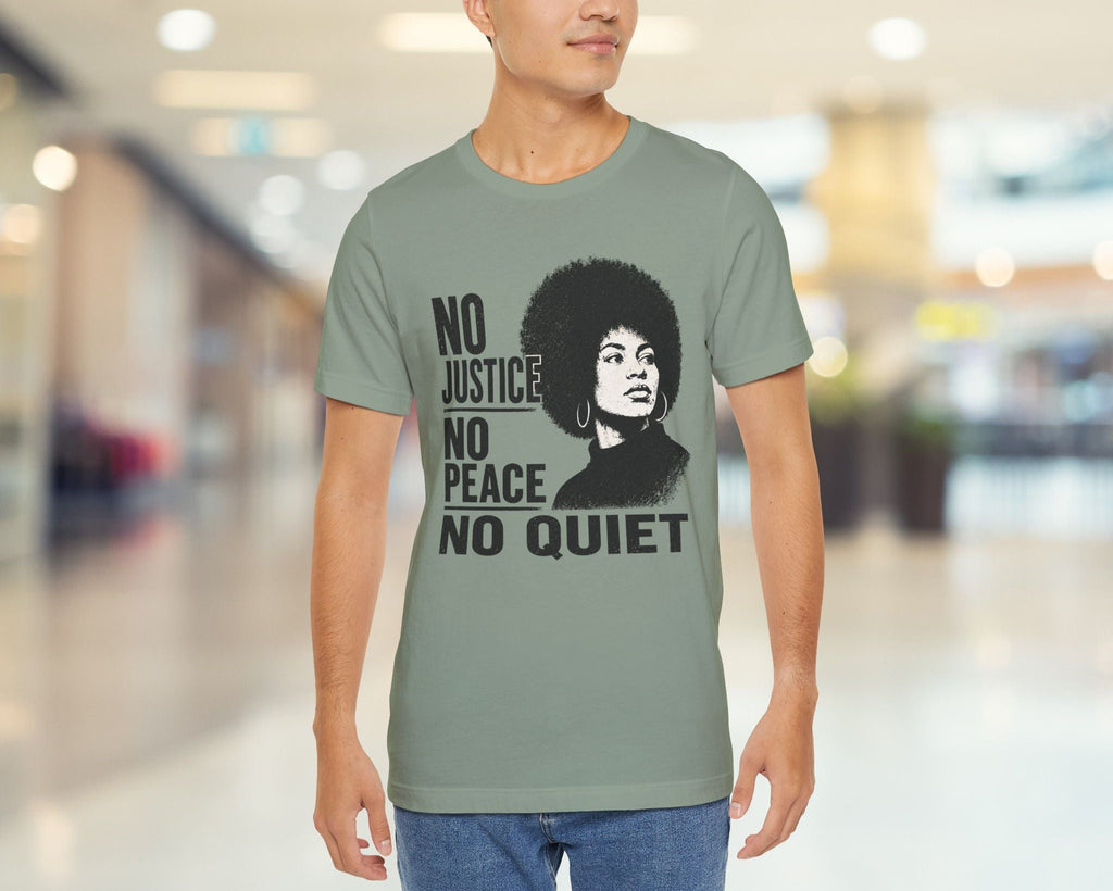 Person wearing a t-shirt with a graphic and text in a blurred indoor setting