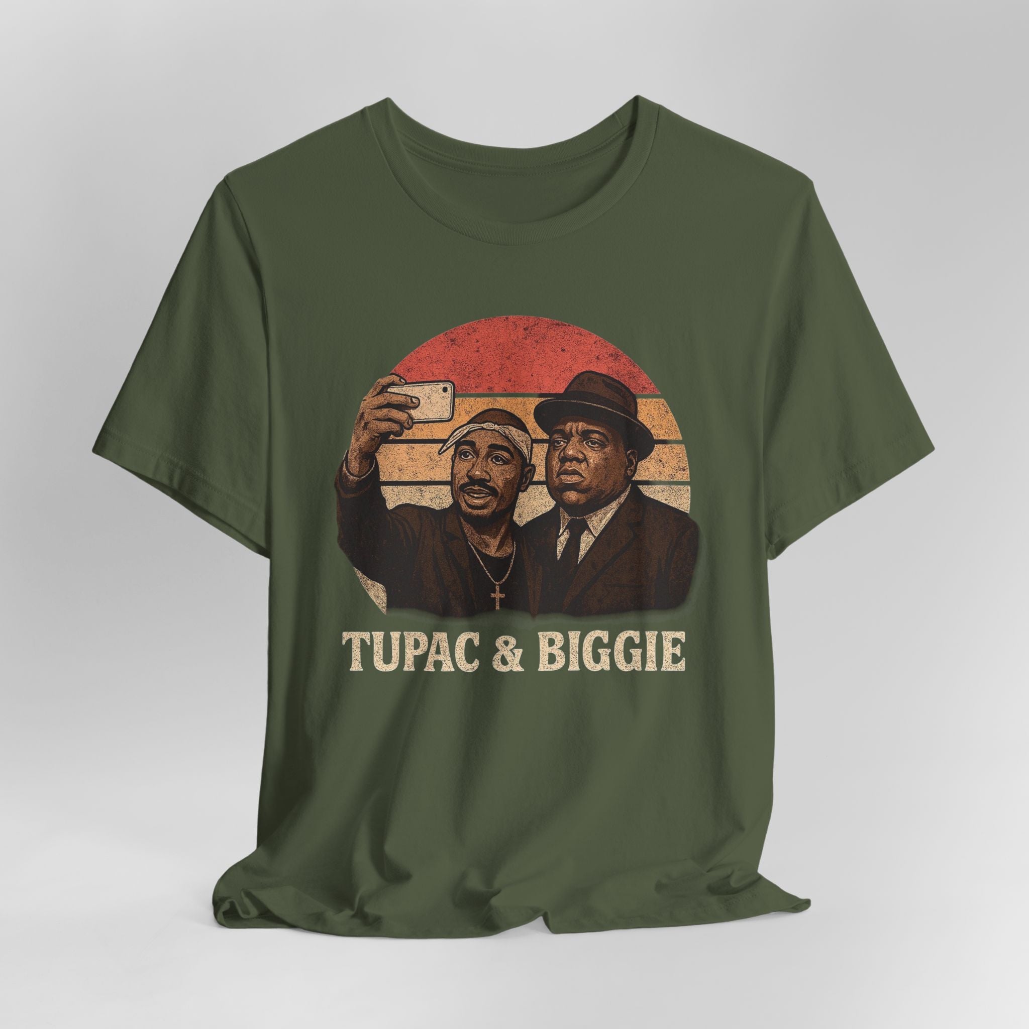 Green t-shirt with graphic of two men and 'Tupac & Biggie' text on a plain background