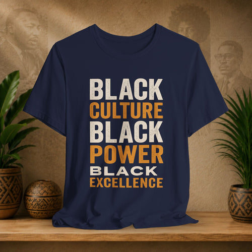 Navy blue t-shirt with 'Black Culture, Black Power, Black Excellence' text on a wooden surface with plants and decorative items.