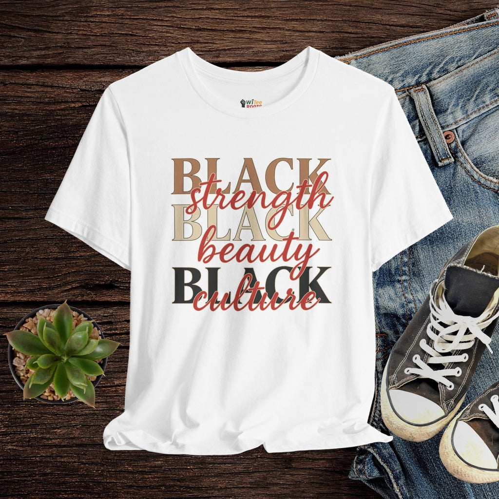 White t-shirt with 'BLACK strength BLACK beauty BLACK culture' text on a wooden surface with jeans and sneakers.