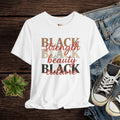 White t-shirt with 'BLACK strength BLACK beauty BLACK culture' text on a wooden surface with jeans and sneakers.