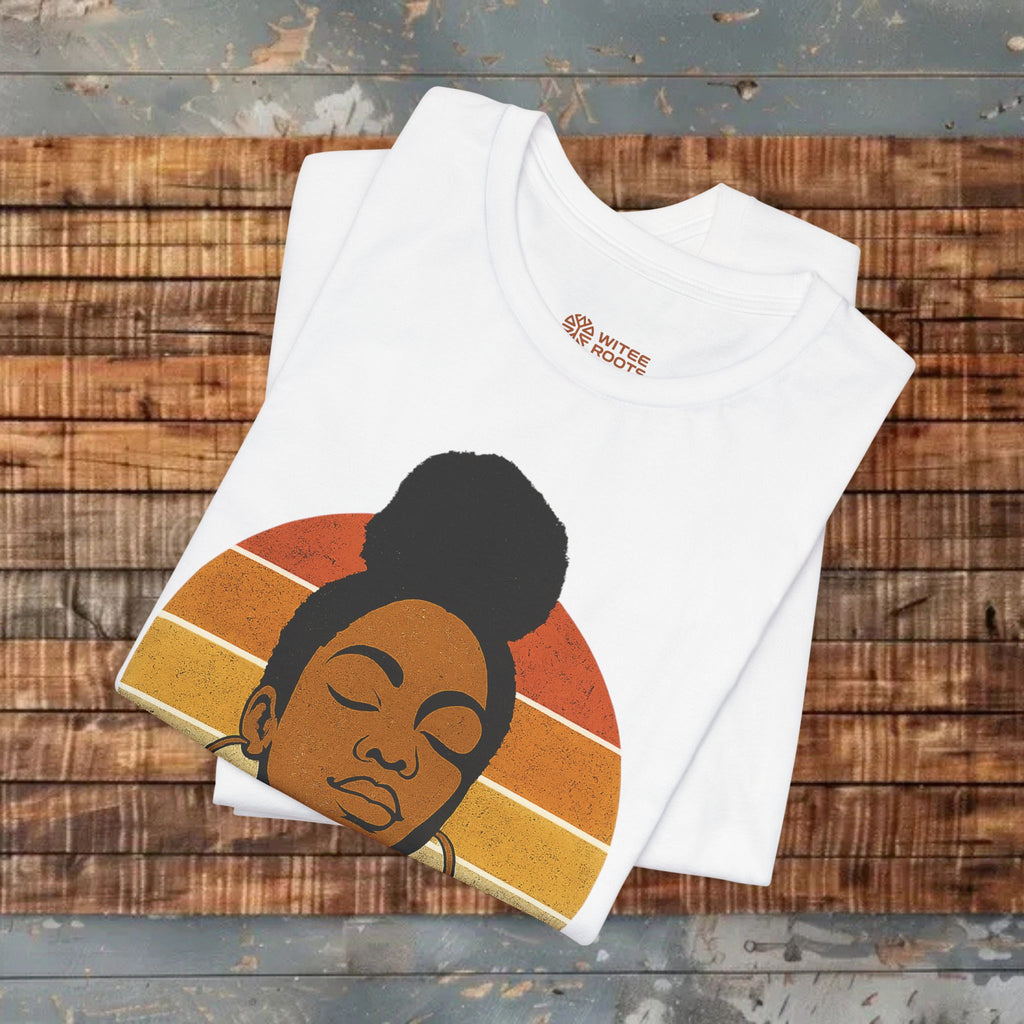 White t-shirt with a graphic of a woman's face on a wooden surface