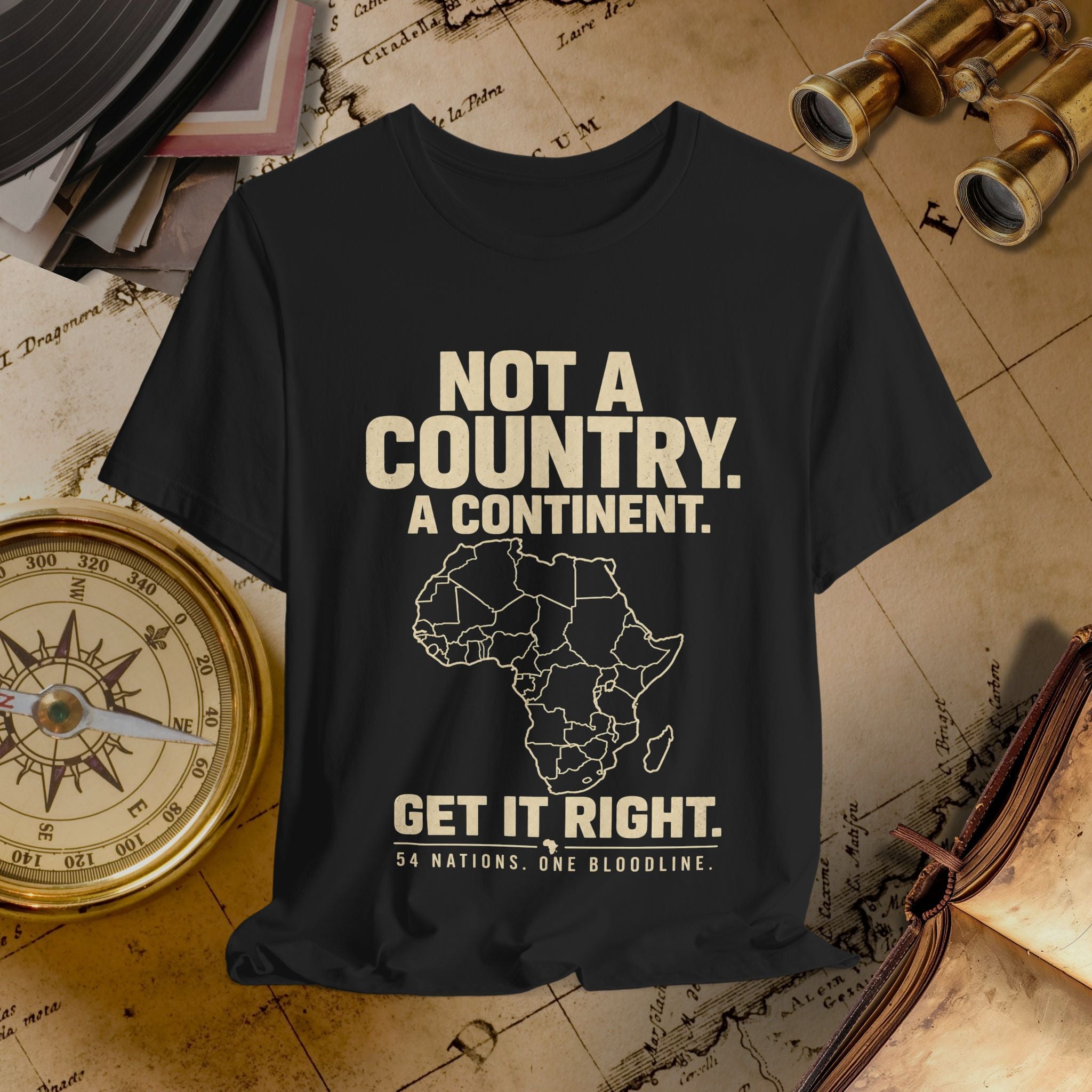 Black t-shirt with text and Africa map graphic on a vintage map background