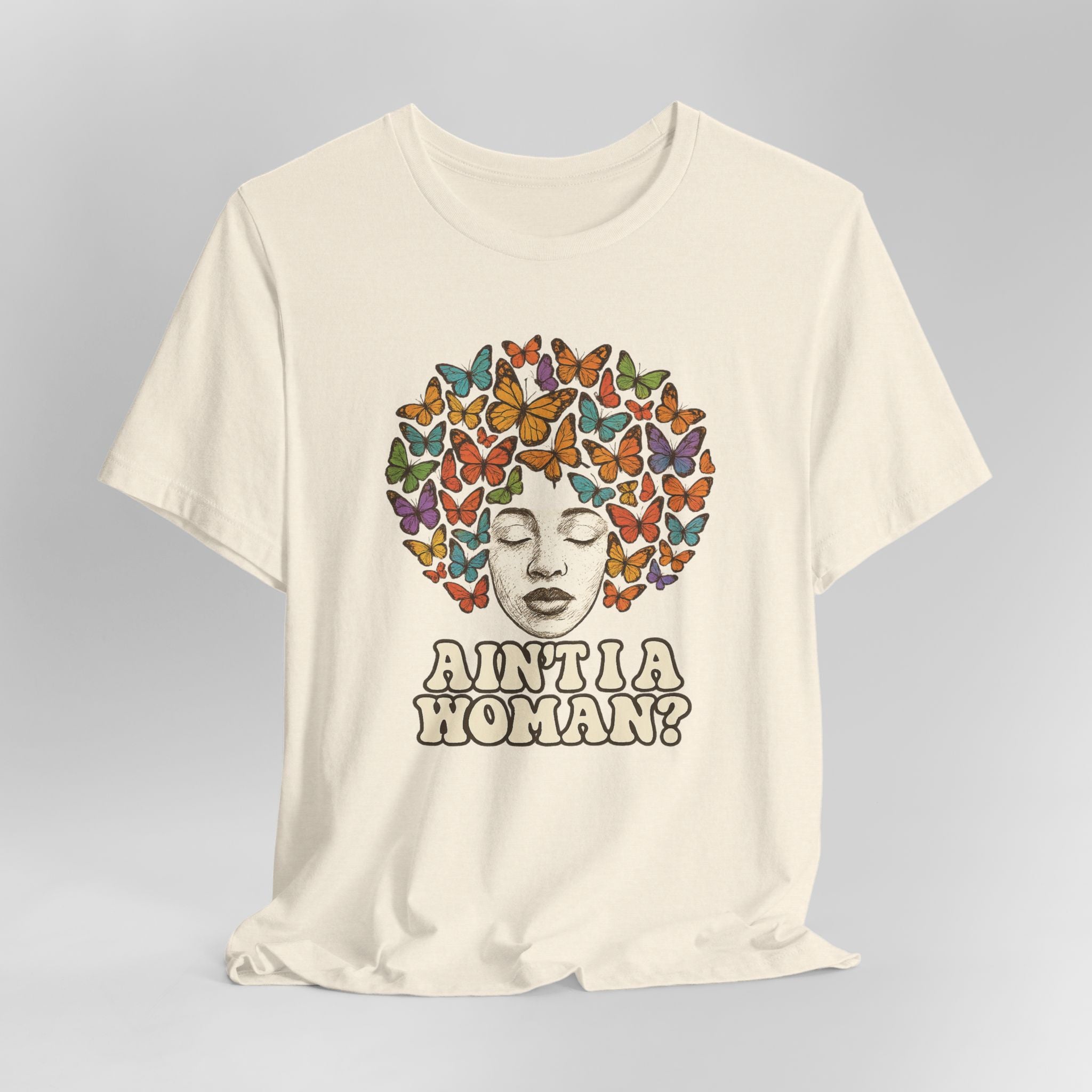 Beige t-shirt with a colorful butterfly design and text on a gray background