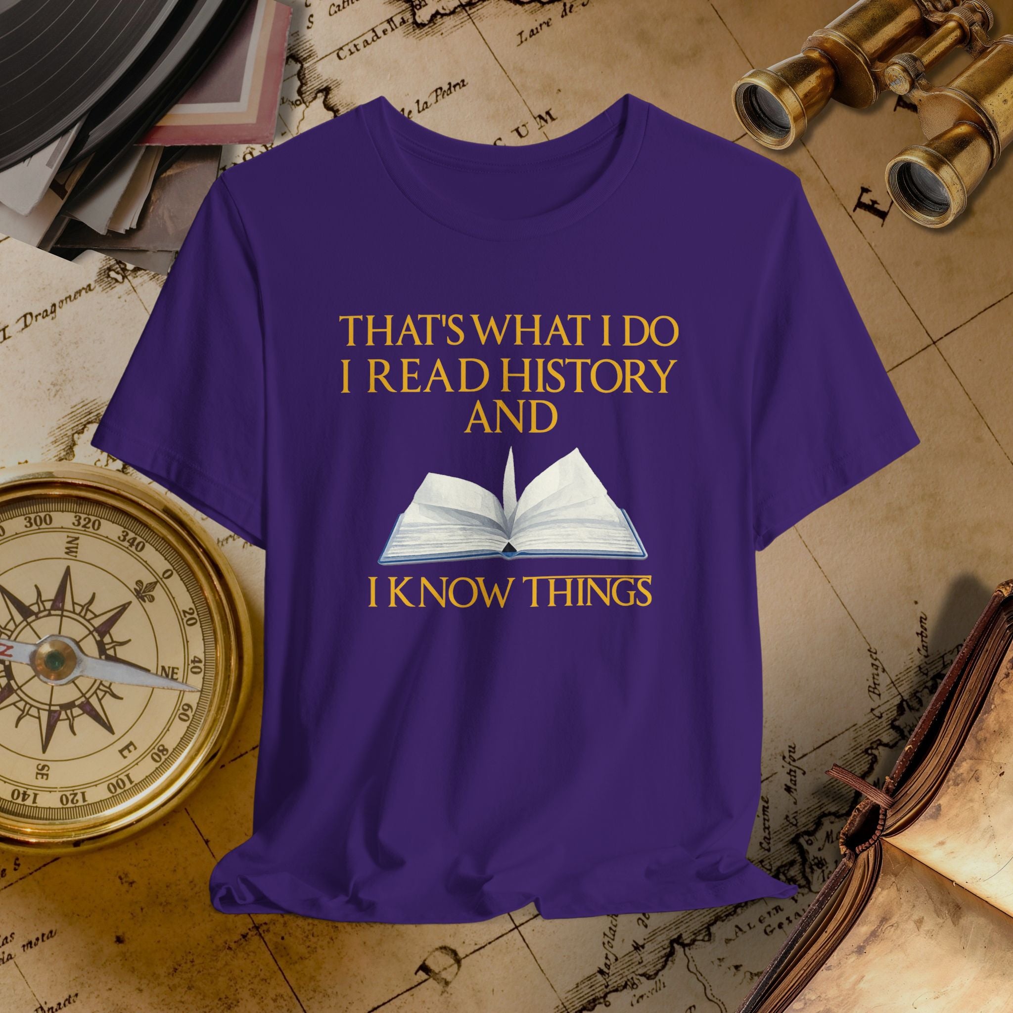 Purple t-shirt with a book graphic and text on a historical-themed background