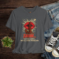 Gray t-shirt with graphic design and text on a wooden surface with jeans and sneakers.