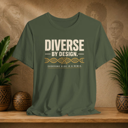 Green t-shirt with 'Diverse by Design' text on a wooden surface with decorative items.