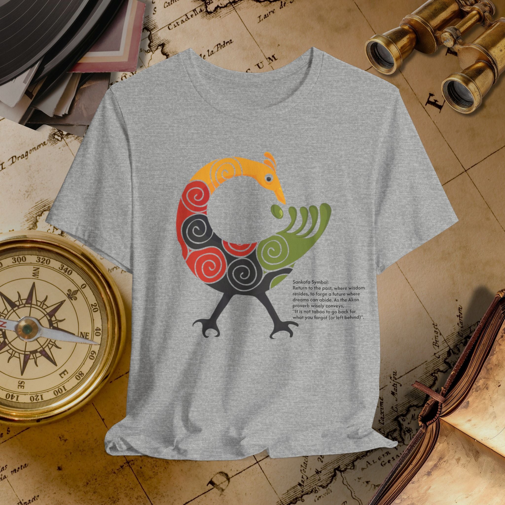 Gray t-shirt with a colorful bird design on a vintage map background