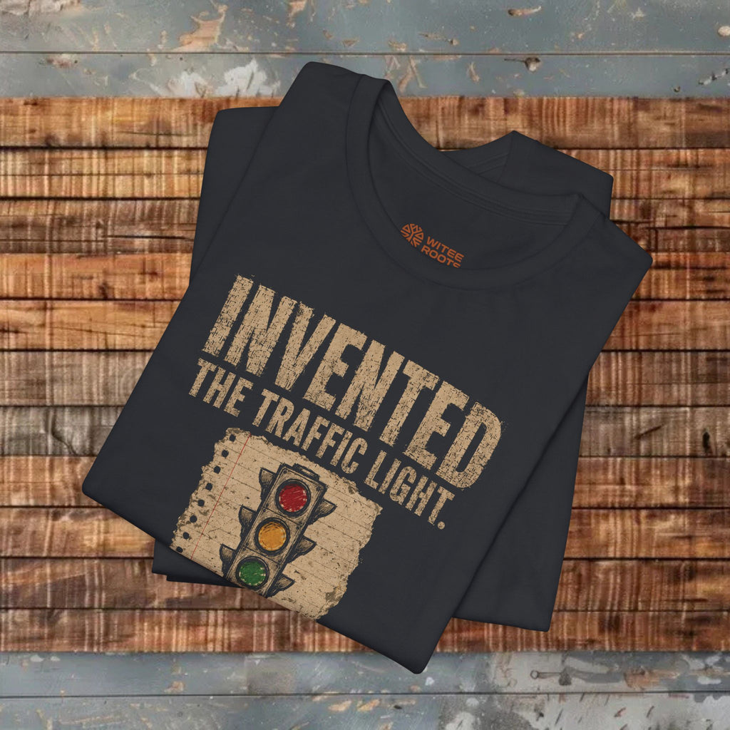 Black t-shirt with 'Invented the Traffic Light' design on a wooden surface