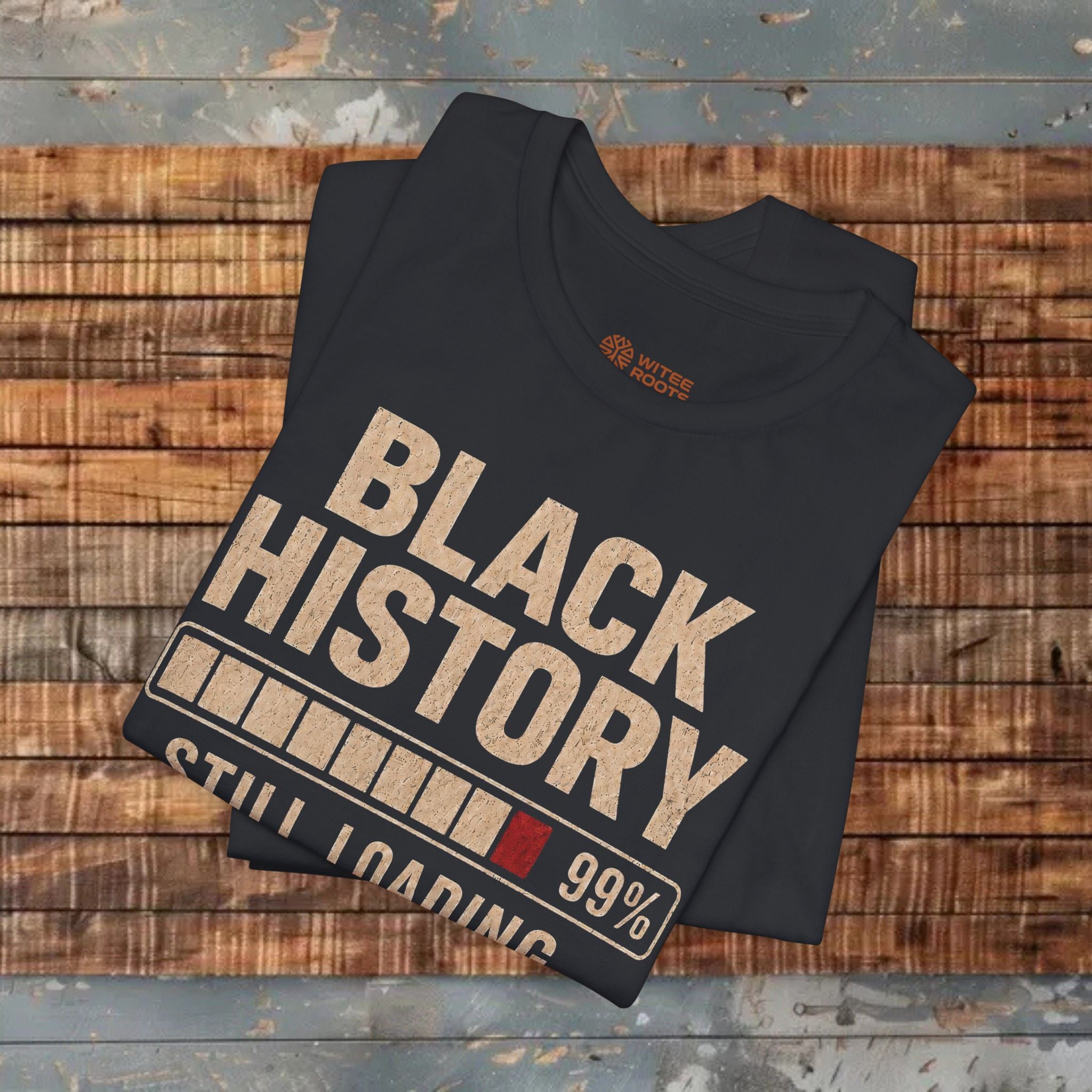 Black t-shirt with 'Black History' graphic on a wooden surface
