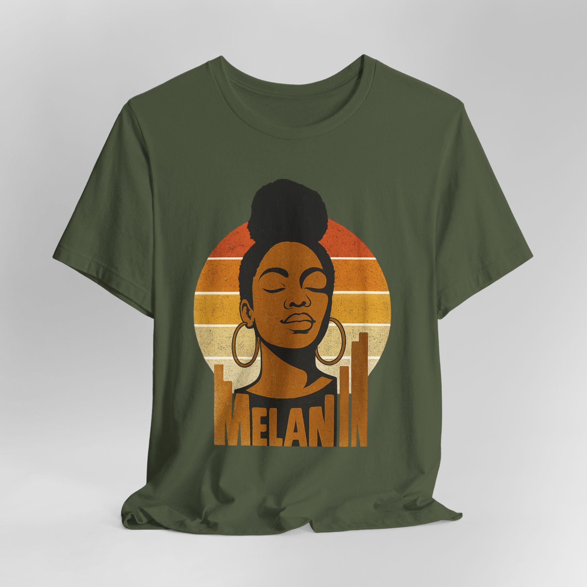 Green t-shirt with a graphic of a woman's face and 'Melanin' text on a gray background