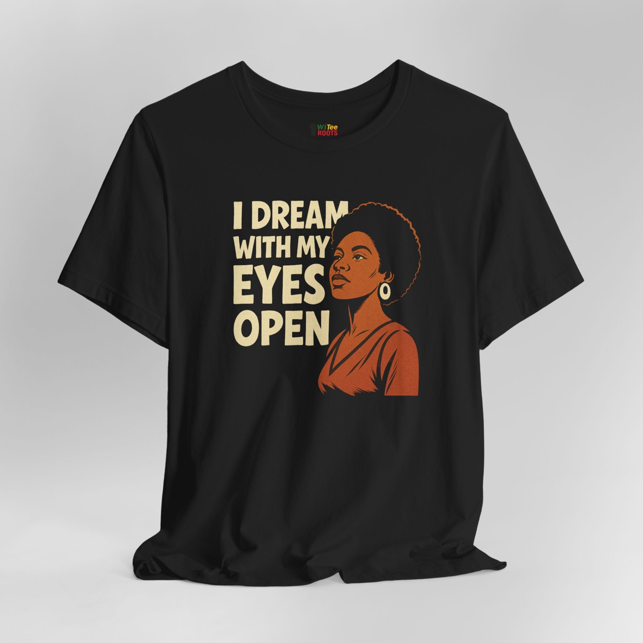 Black t-shirt with a graphic of a woman and text 'I Dream with My Eyes Open' on a gray background