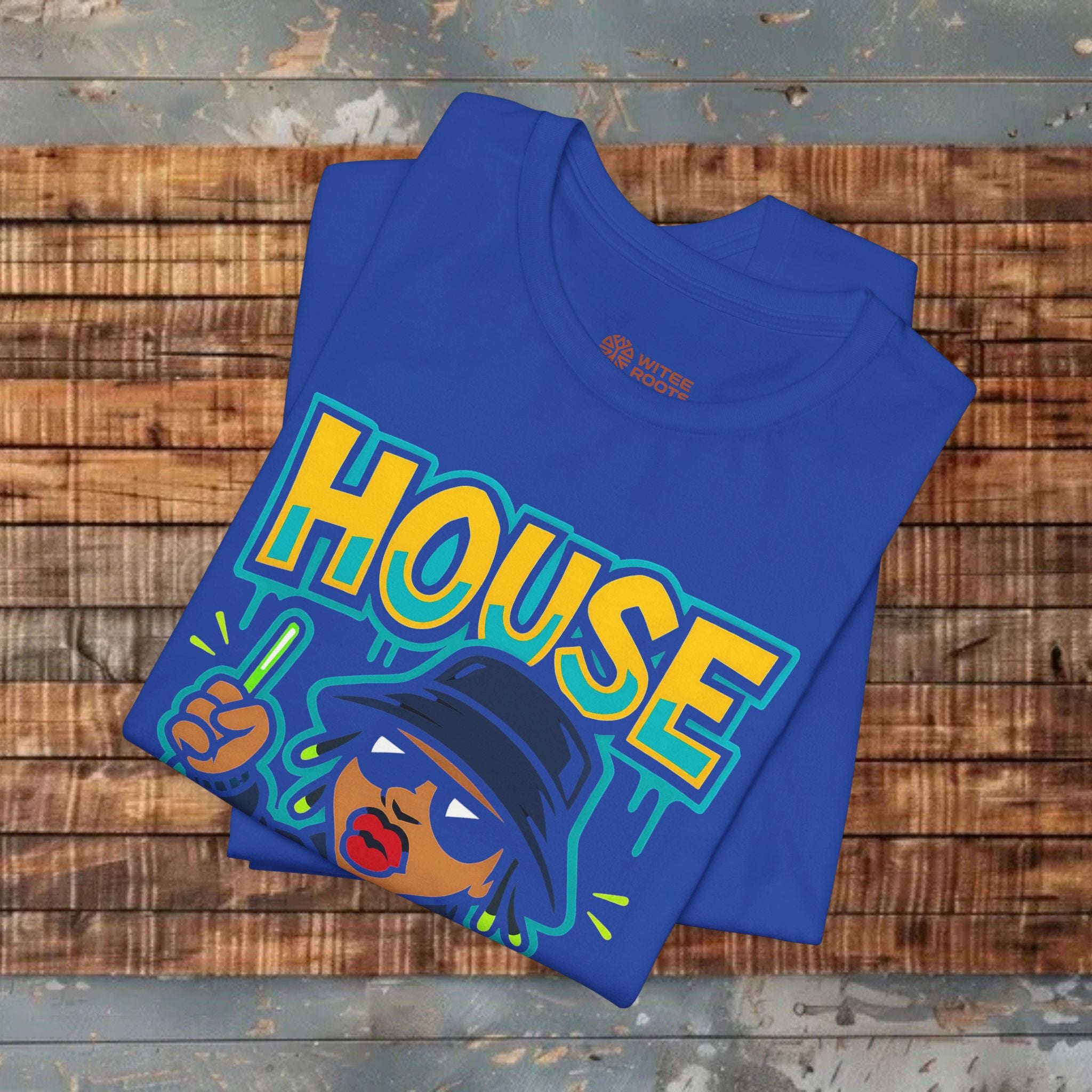 Folded blue t-shirt with colorful 'HOUSE' design on a wooden surface