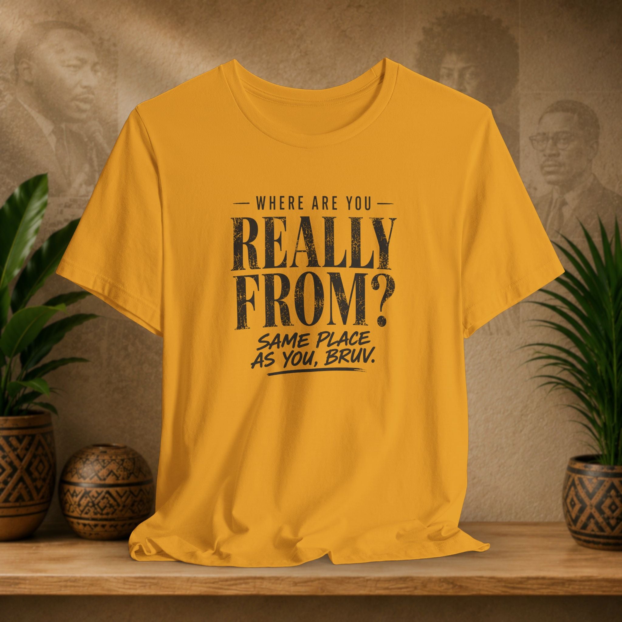 Mustard t-shirt with text on a wooden surface with plants and a textured wall background