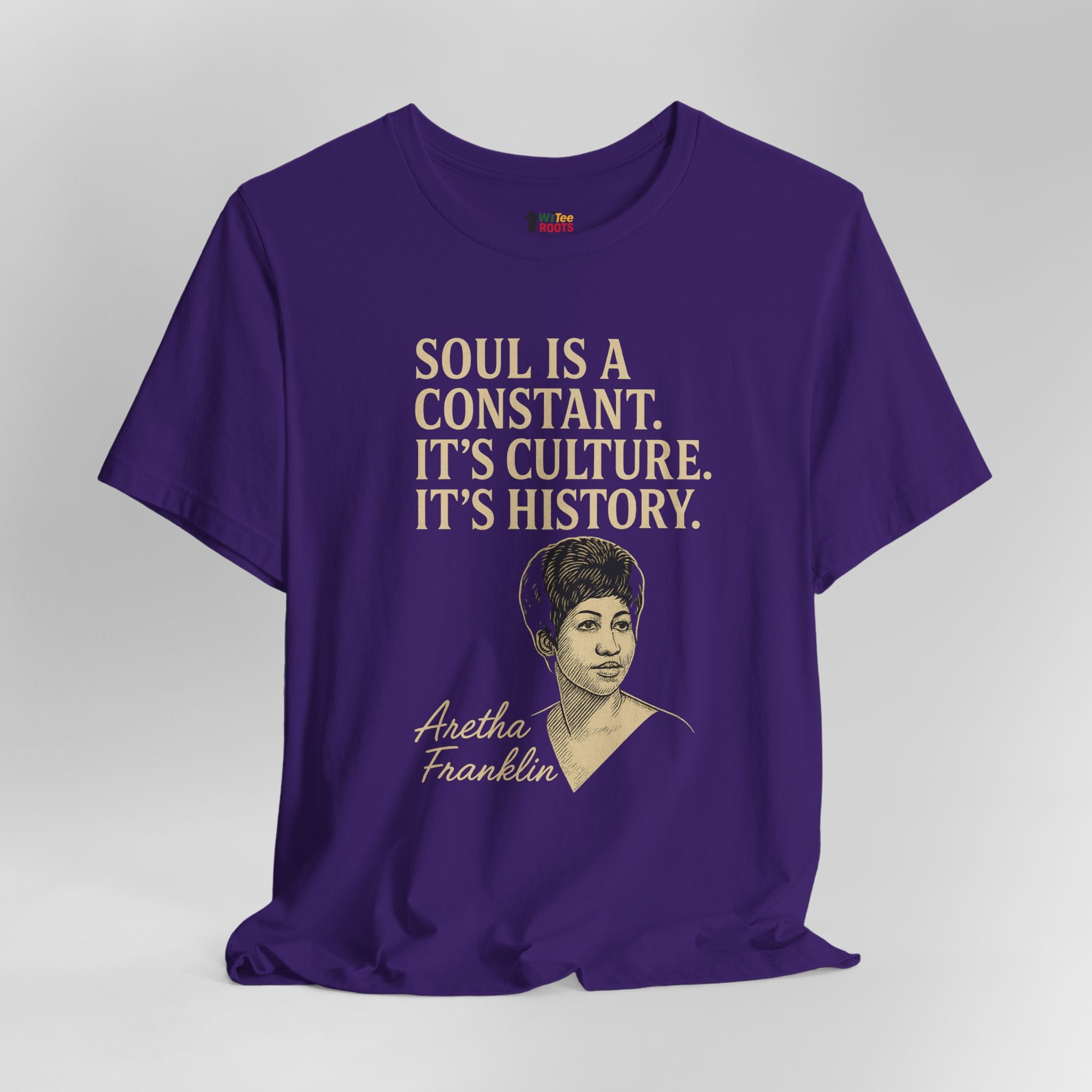 Purple t-shirt with text and a portrait of Aretha Franklin on a gray background