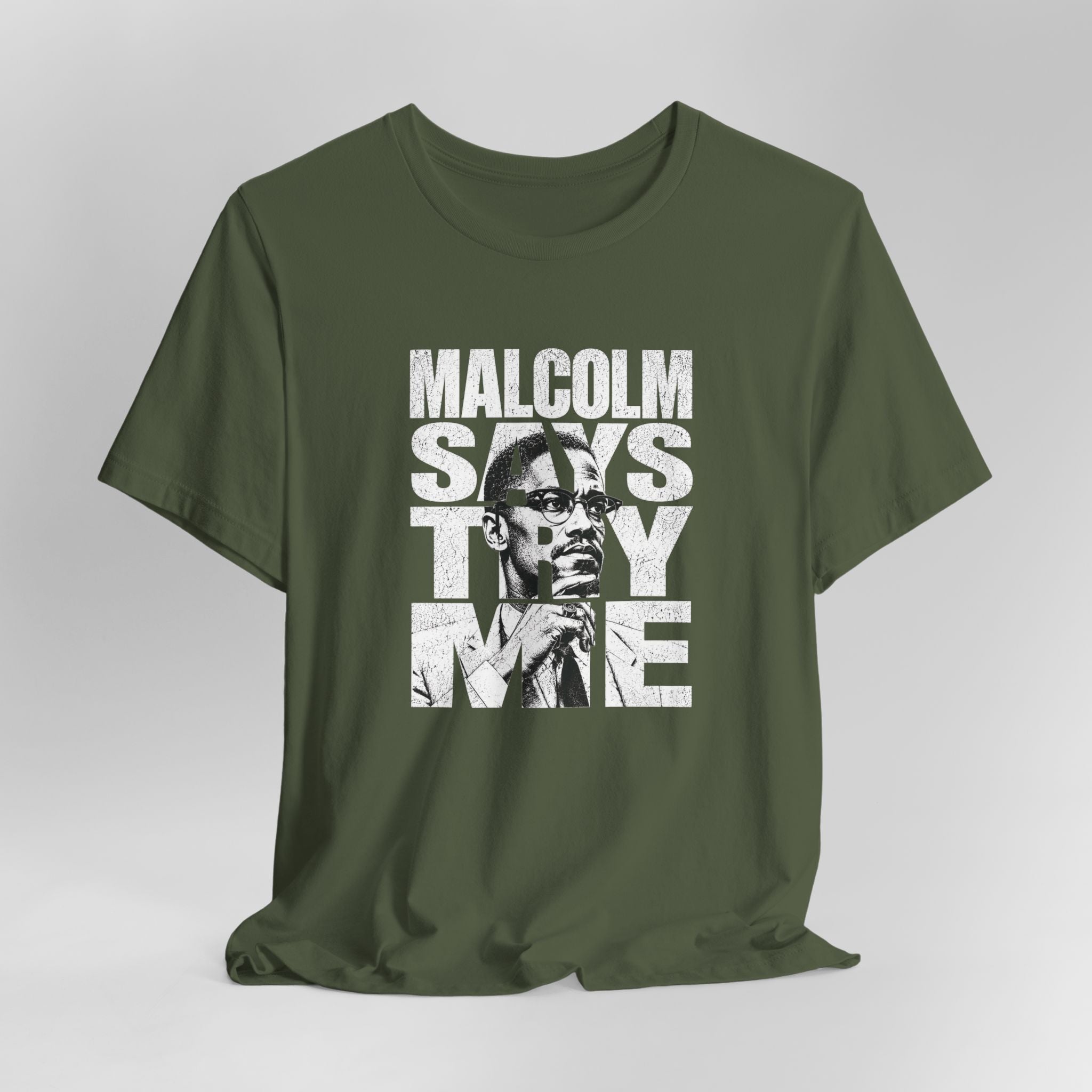Green t-shirt with a graphic of a man and text on a gray background