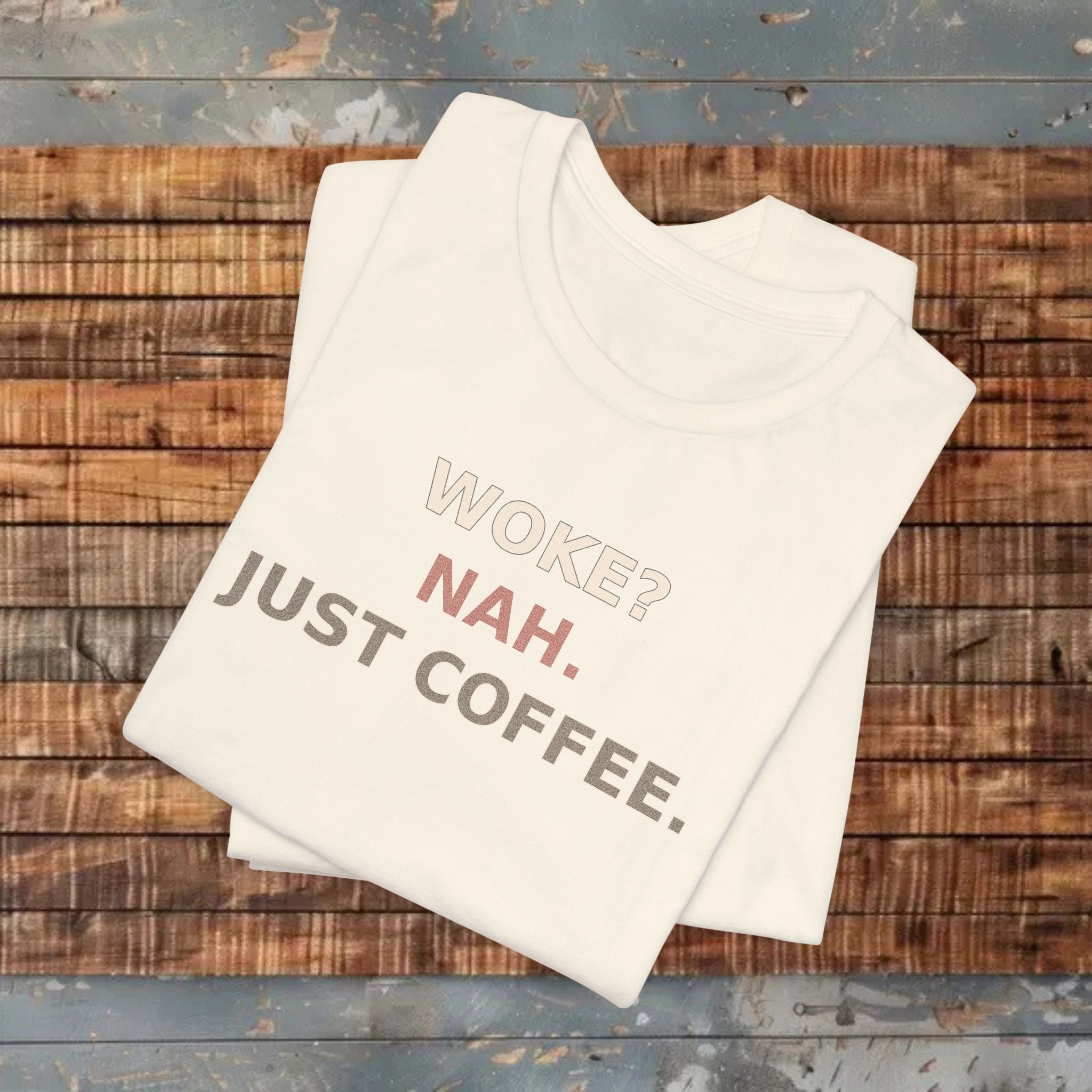 Beige t-shirt with humorous text on a wooden surface