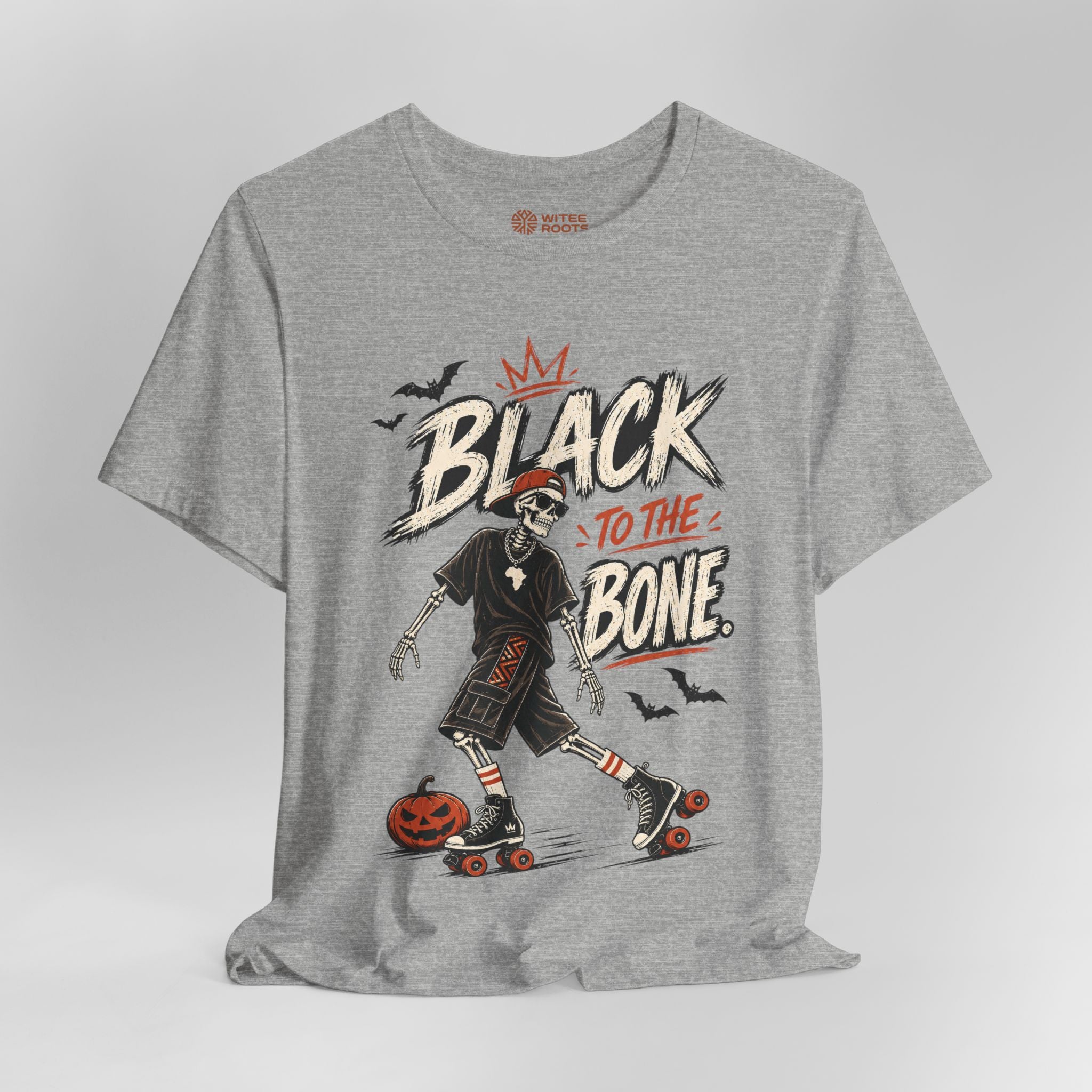 A heather gray short-sleeve t-shirt with a graphic print of a skeleton roller skate and the text 'BLACK TO THE BONE' with small bats and a pumpkin, shown on a light gray background.