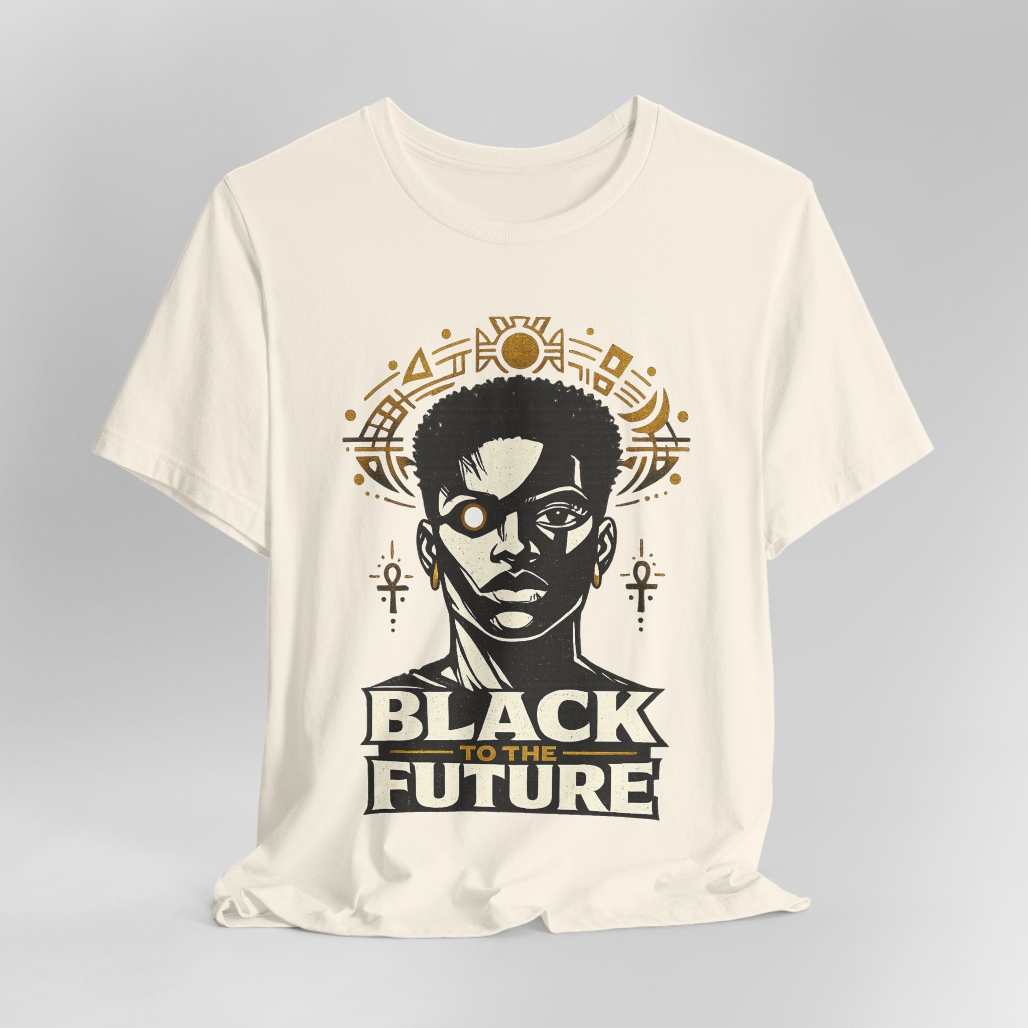 Beige t-shirt with a graphic design featuring a silhouette of a person and the text 'Black to the Future' on a gray background.