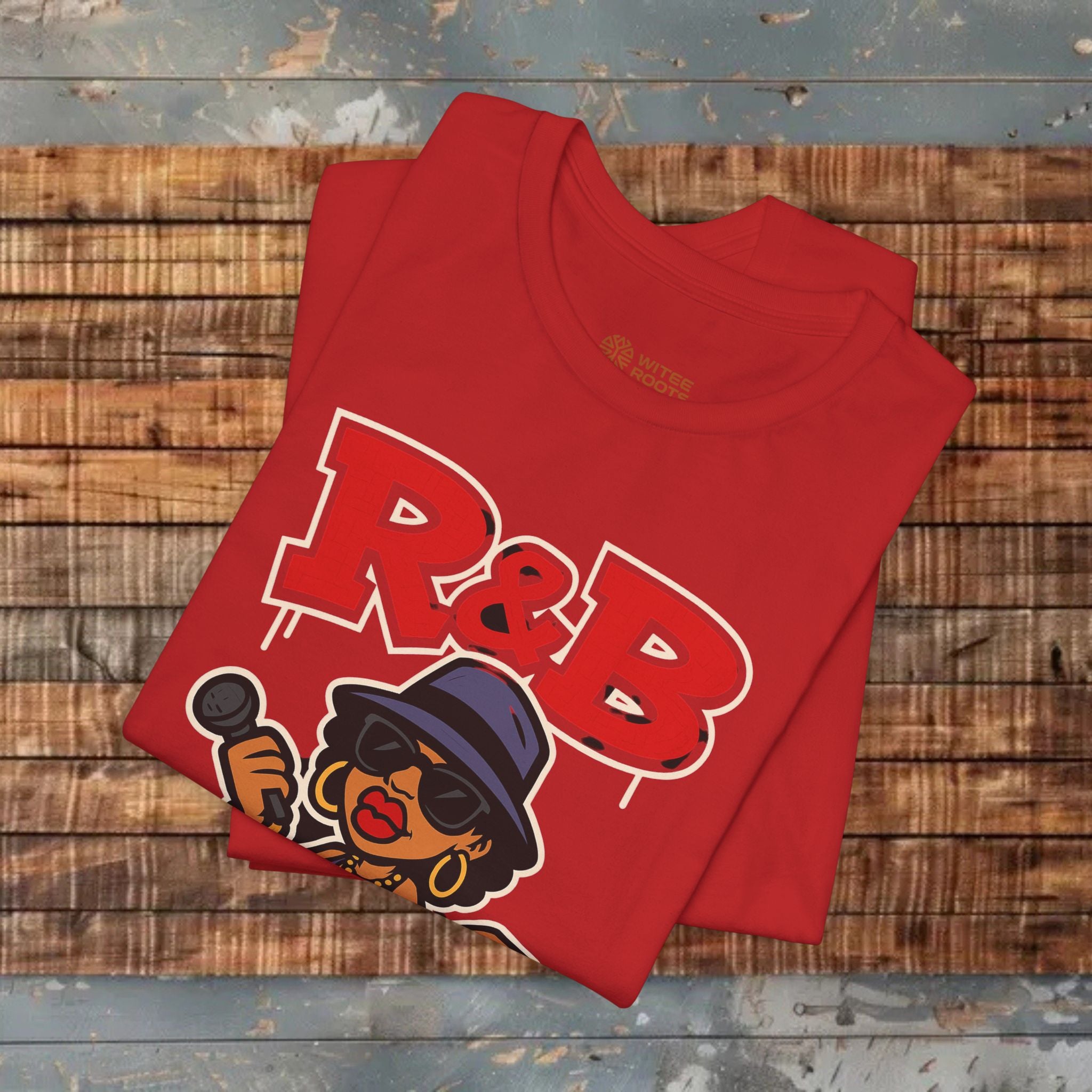 Red t-shirt with 'R&B' design on a wooden surface