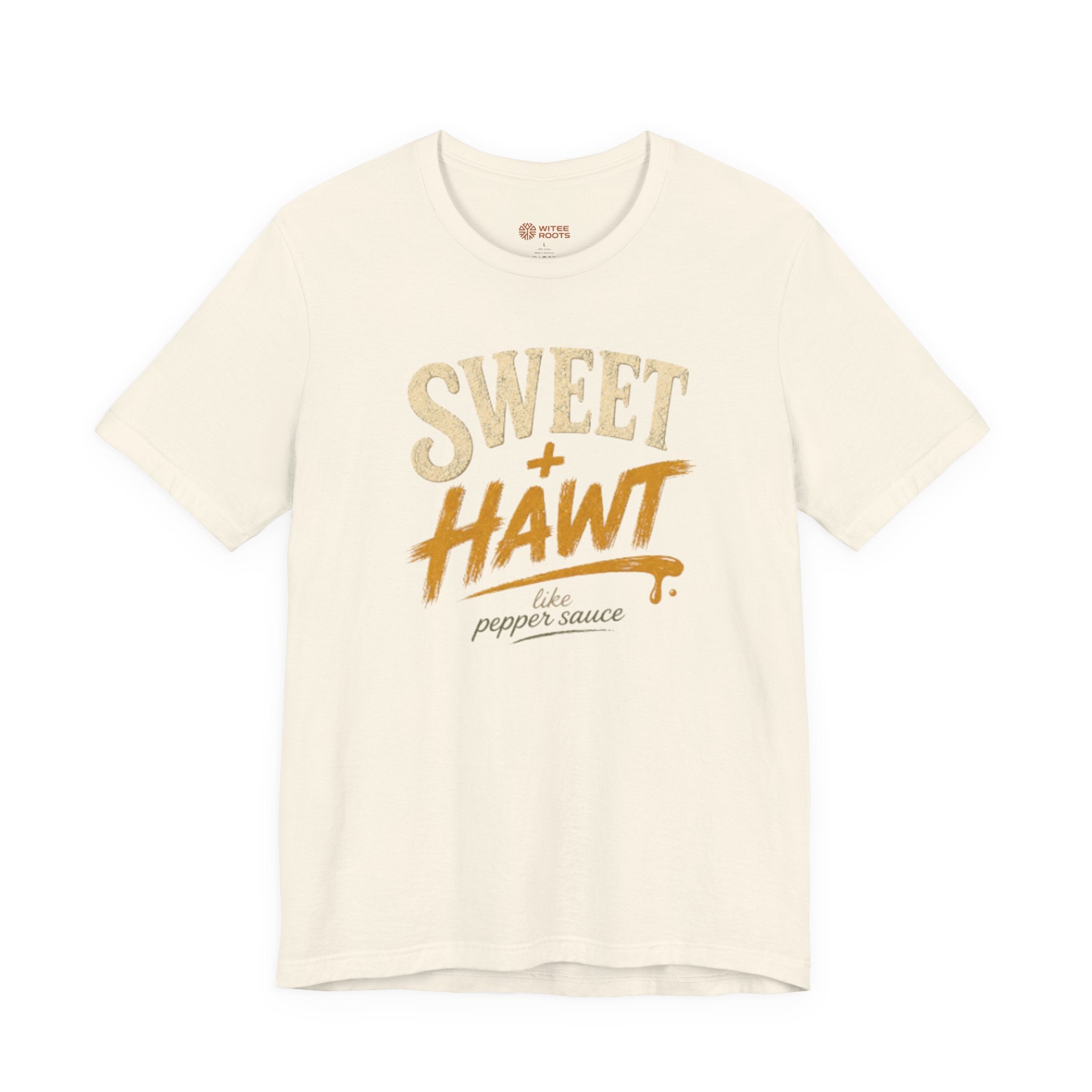 An off-white short-sleeve t-shirt with a graphic print on the front reading 'SWEET + HAWT like pepper sauce' in textured beige and orange lettering, displayed on a clean white background.