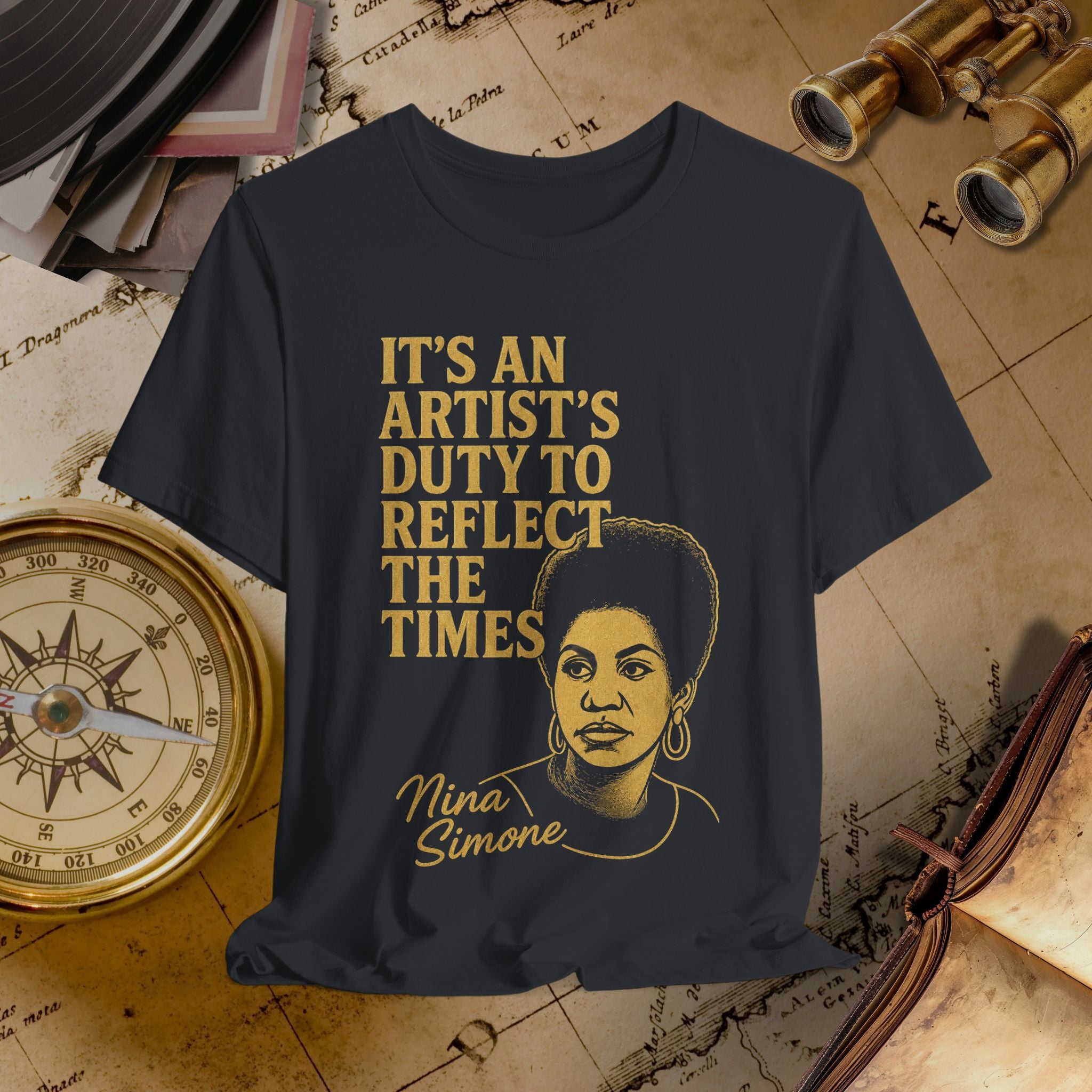 Black t-shirt with gold text and Nina Simone graphic on a vintage map background