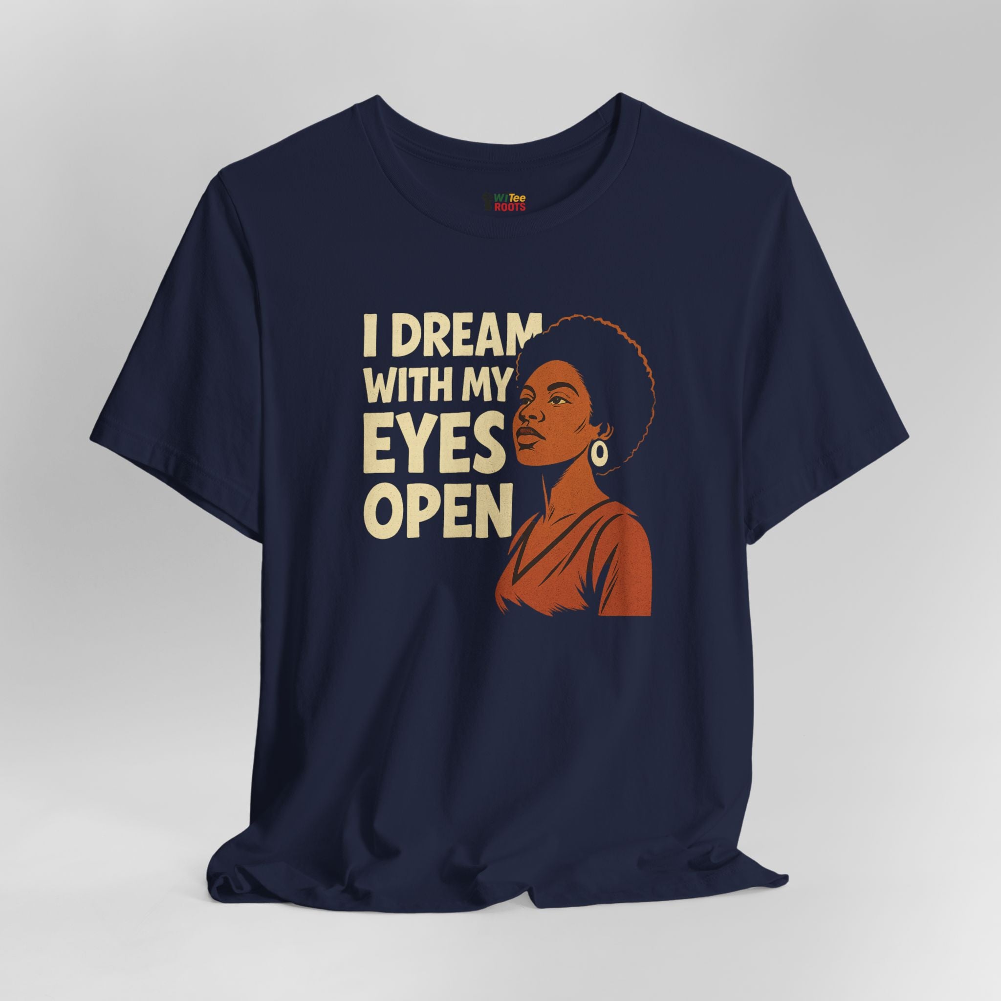 Navy blue t-shirt with a graphic of a woman and text 'I Dream with My Eyes Open' on a gray background