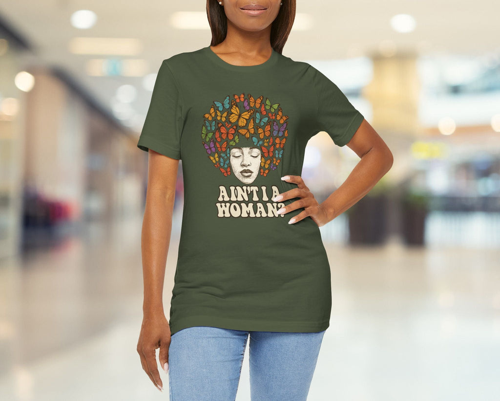 Woman wearing a green t-shirt with a graphic design and text in a blurred indoor setting