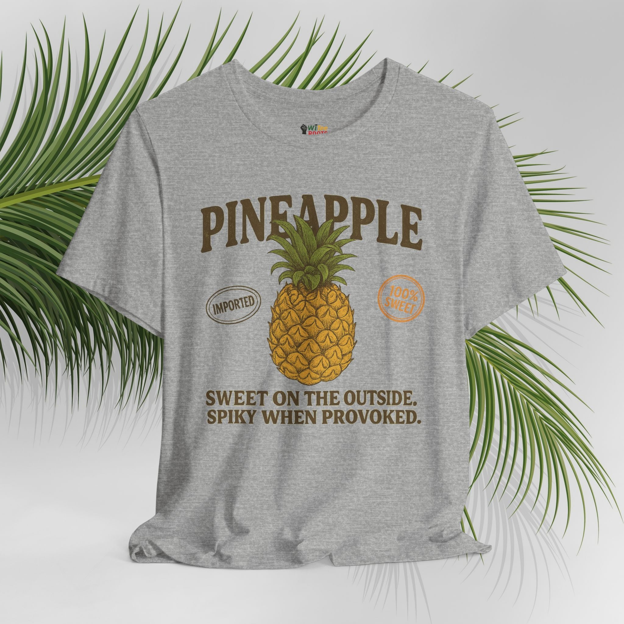 Gray t-shirt with pineapple graphic and text on a white background with green leaves.