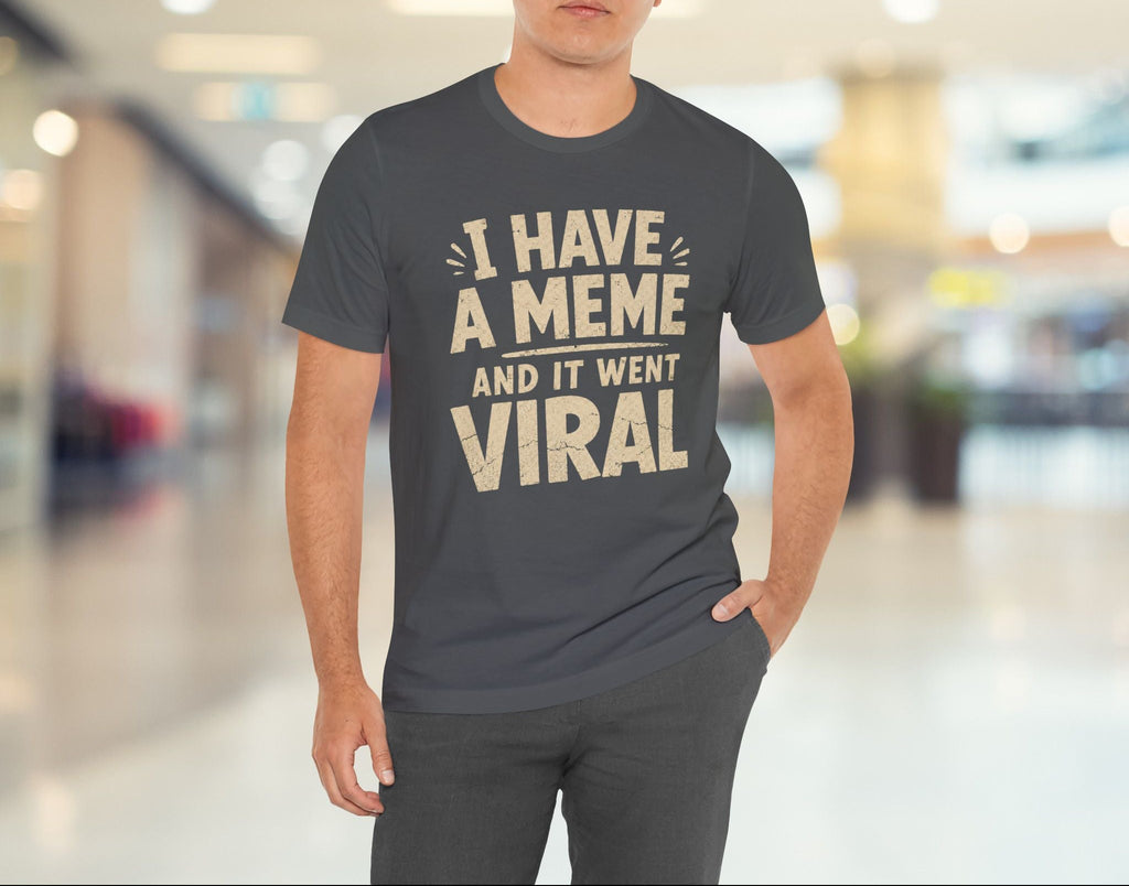 Man wearing a t-shirt with text in a blurred indoor setting