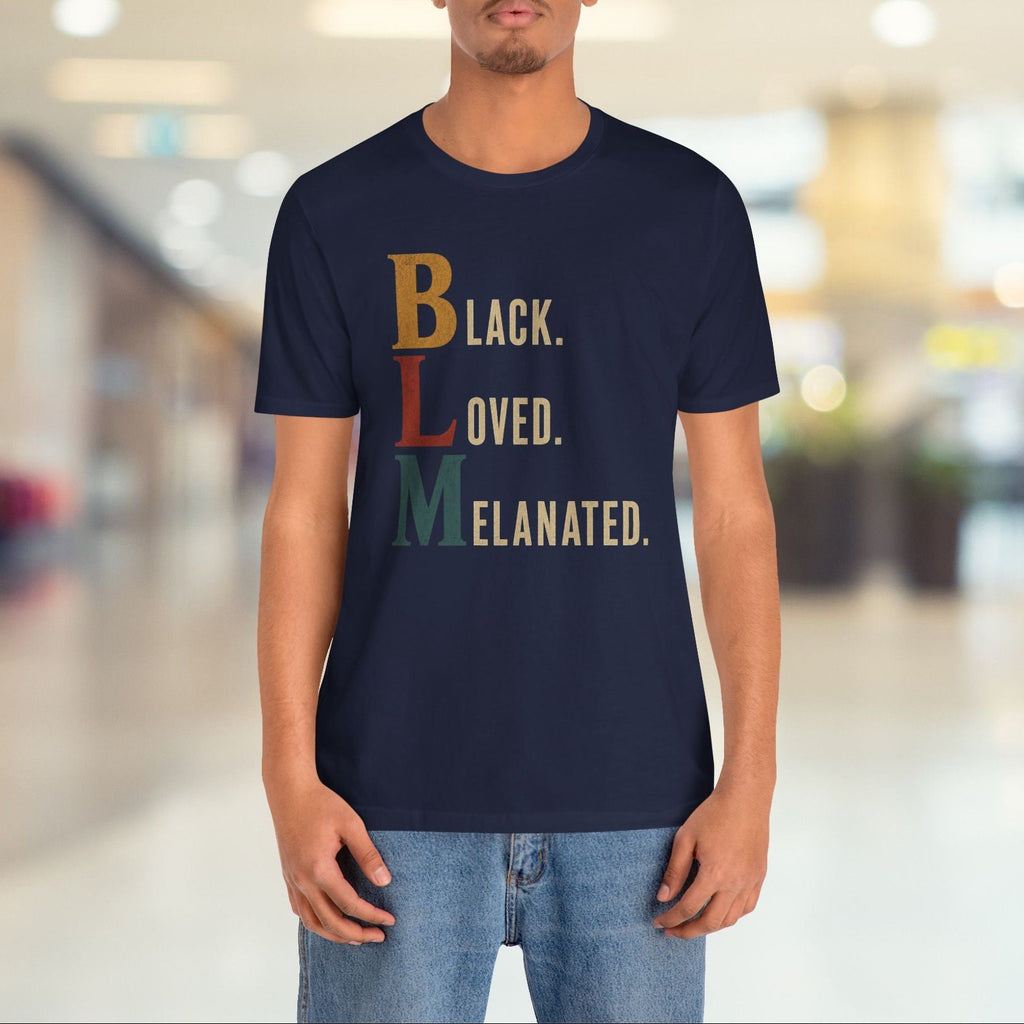 A man wearing a navy blue t-shirt with a retro-style stacked text graphic reading 'BLACK. LOVED.
