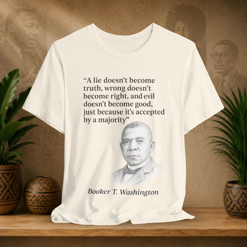 Beige t-shirt with Booker T. Washington quote on a wooden surface with plants and portraits in the background