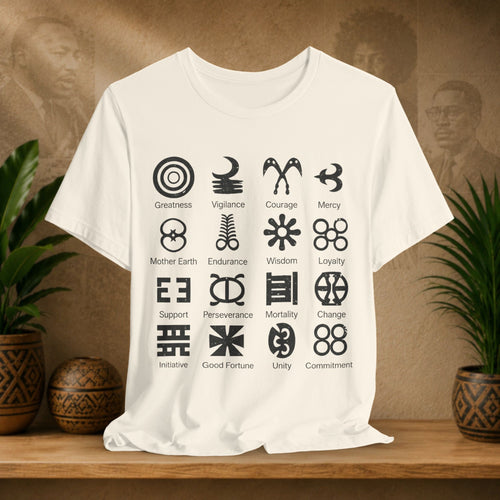 Beige t-shirt with black symbols and text on a wooden surface with plants and a textured wall in the background
