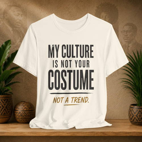 Beige t-shirt design on a wooden surface with plants and a decorative wall.