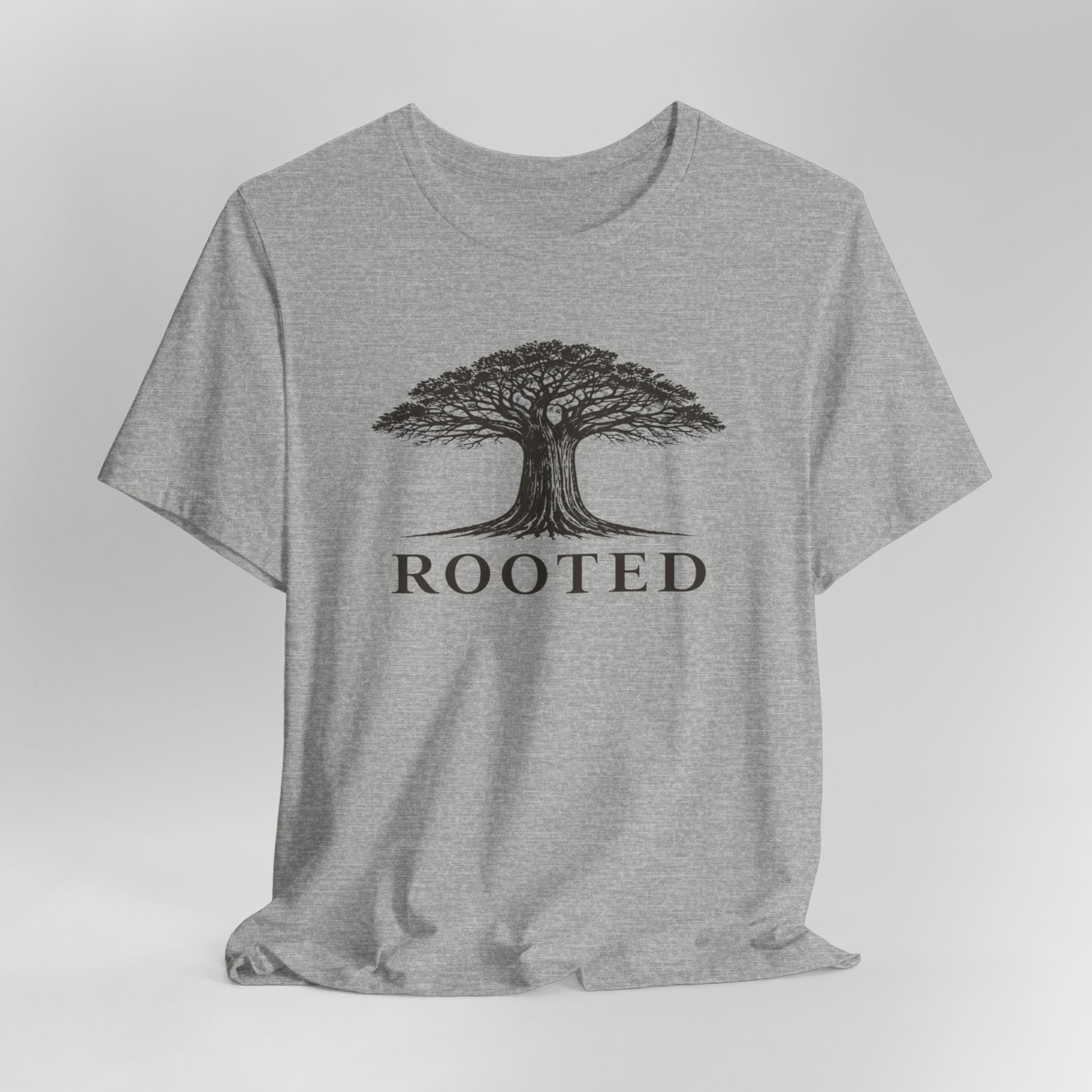 Gray t-shirt with a tree graphic and 'ROOTED' text on a white background