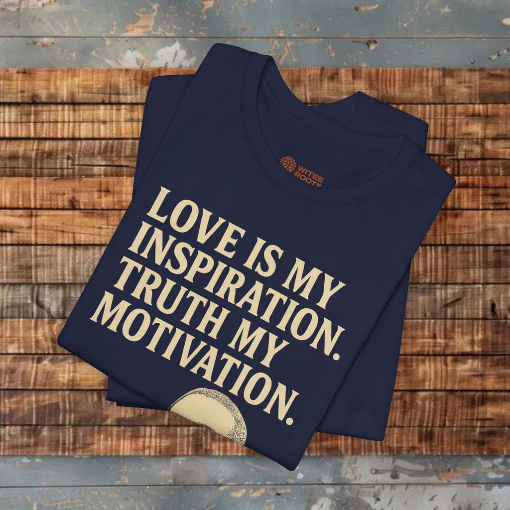 Folded navy blue t-shirt with motivational quote on a wooden surface